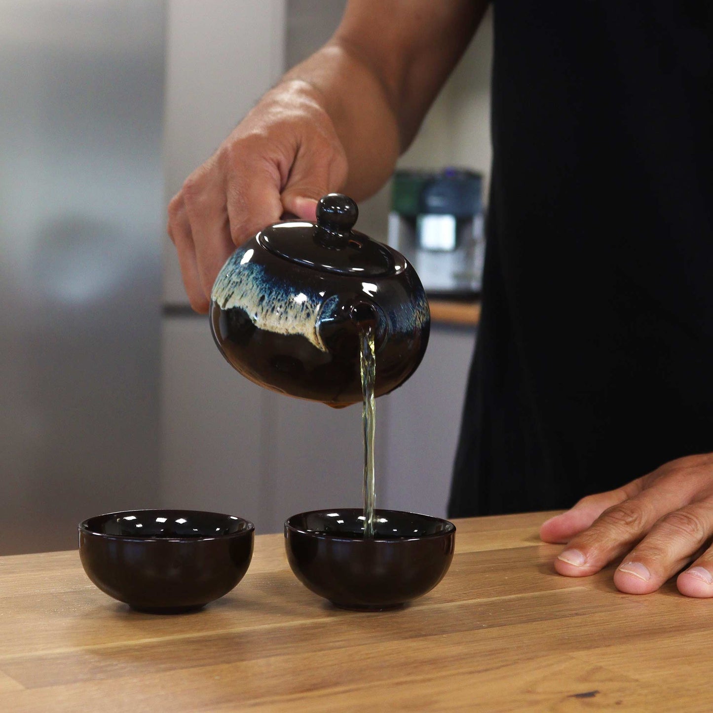 200ml Black Glazed Ceramic Teapot Pouring Tea into a Matching Cup