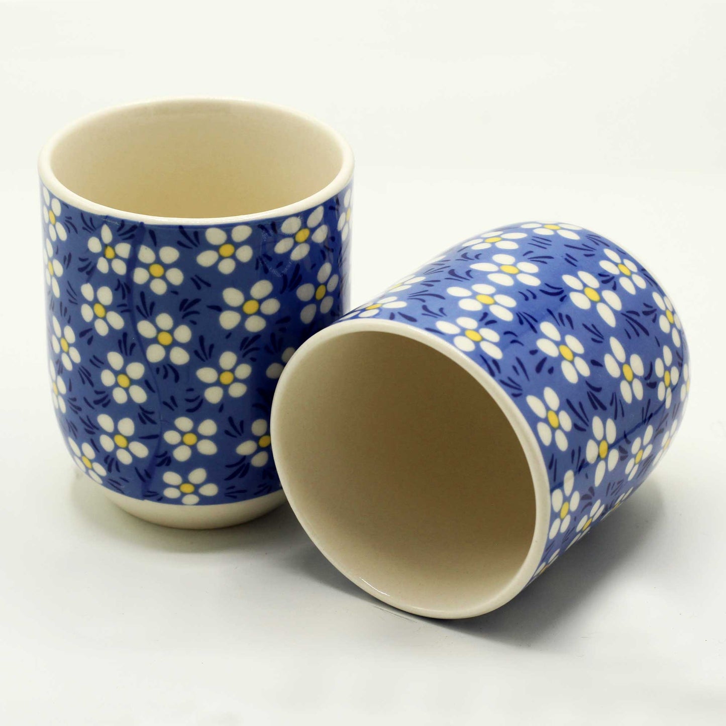 2 Ceramic Blue Daisy Tea Cups with One Lying Down