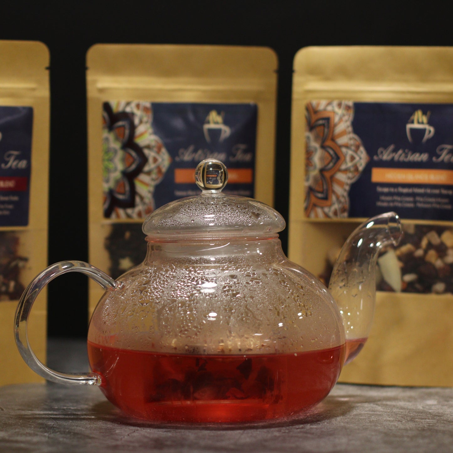 400ml Glass Round Pearl Infuser Teapot Sitting in front of Tea Sachets