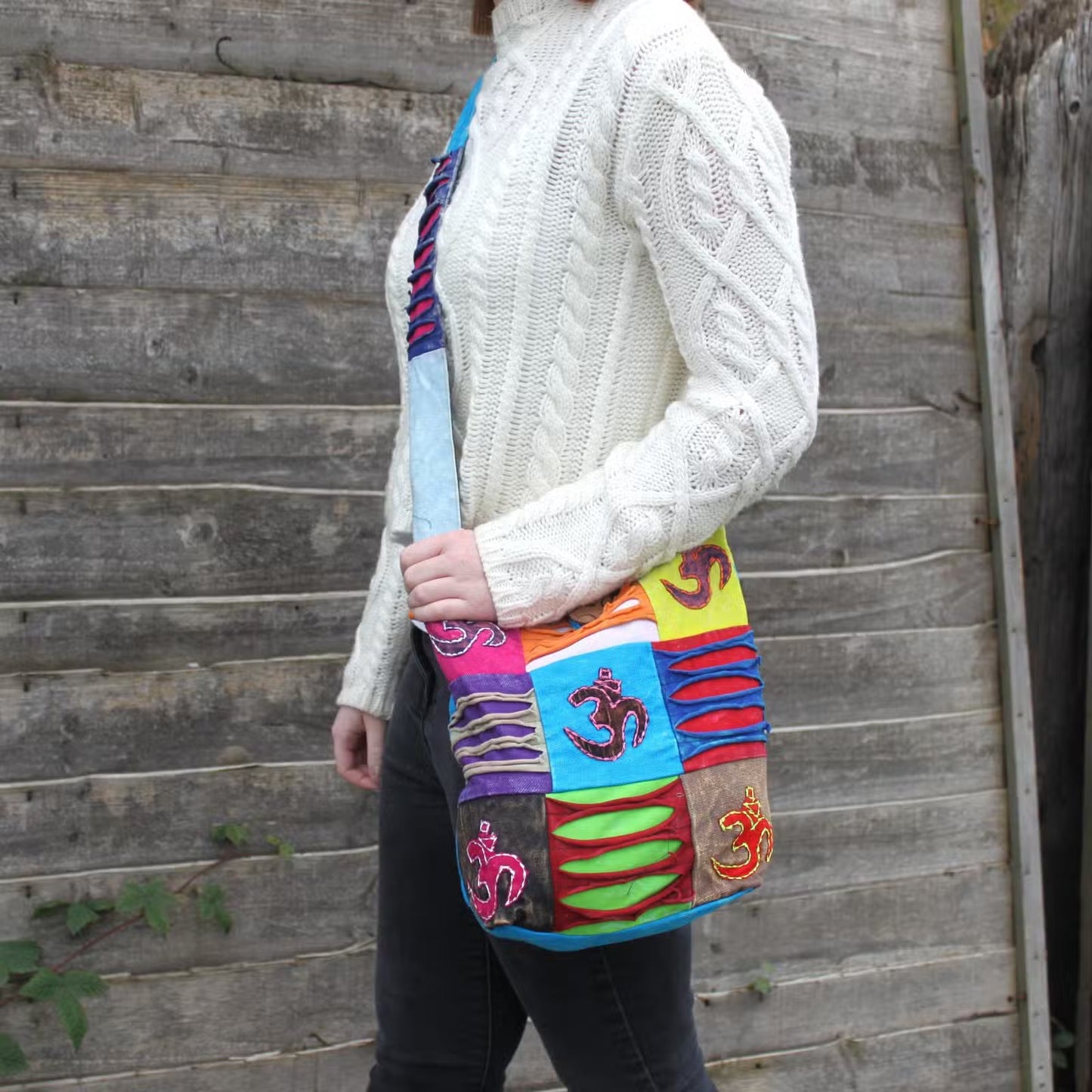 Ethnic Cotton Sling Bag - Teal - Om, colourful rectangular bag with teal panel and Om motifs shown on a person by Quintessential Holistic Health Ltd