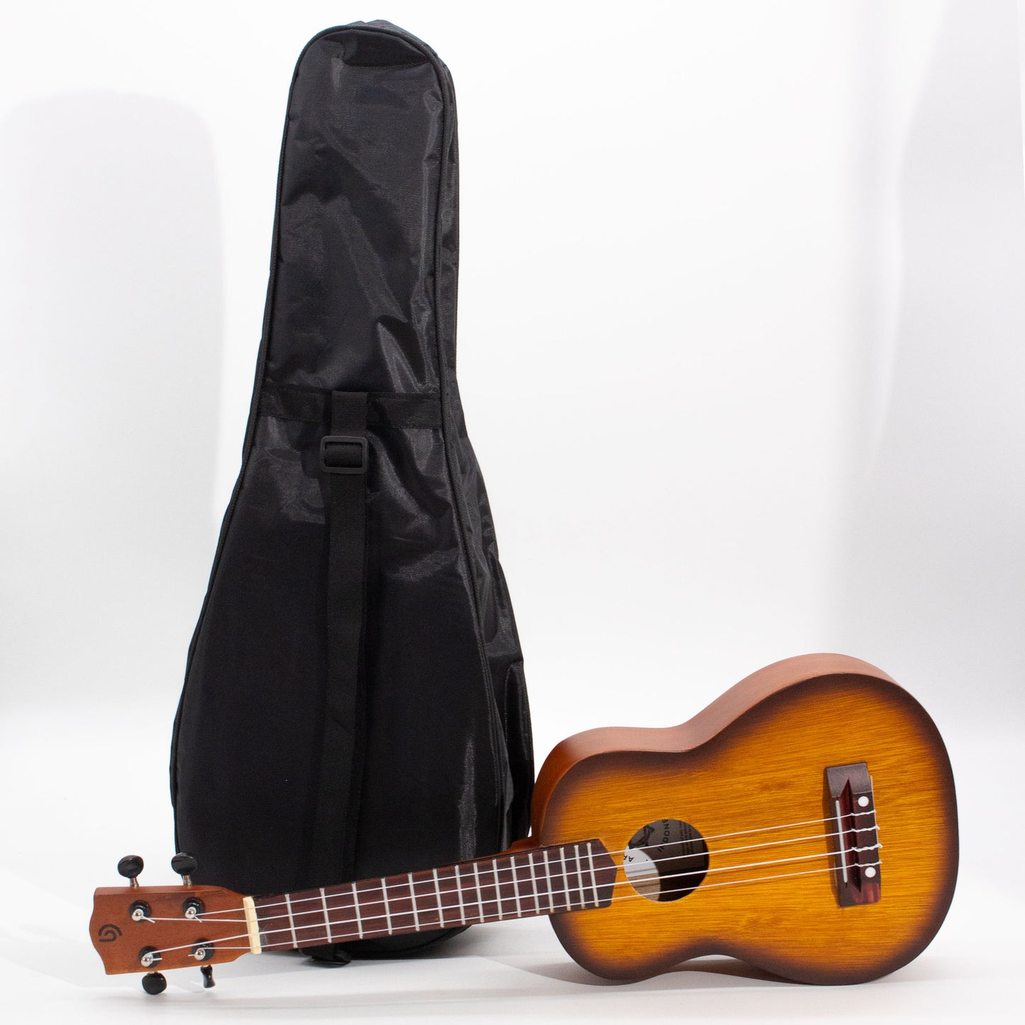 Artisan Made Ukulele lying down next to the carry case