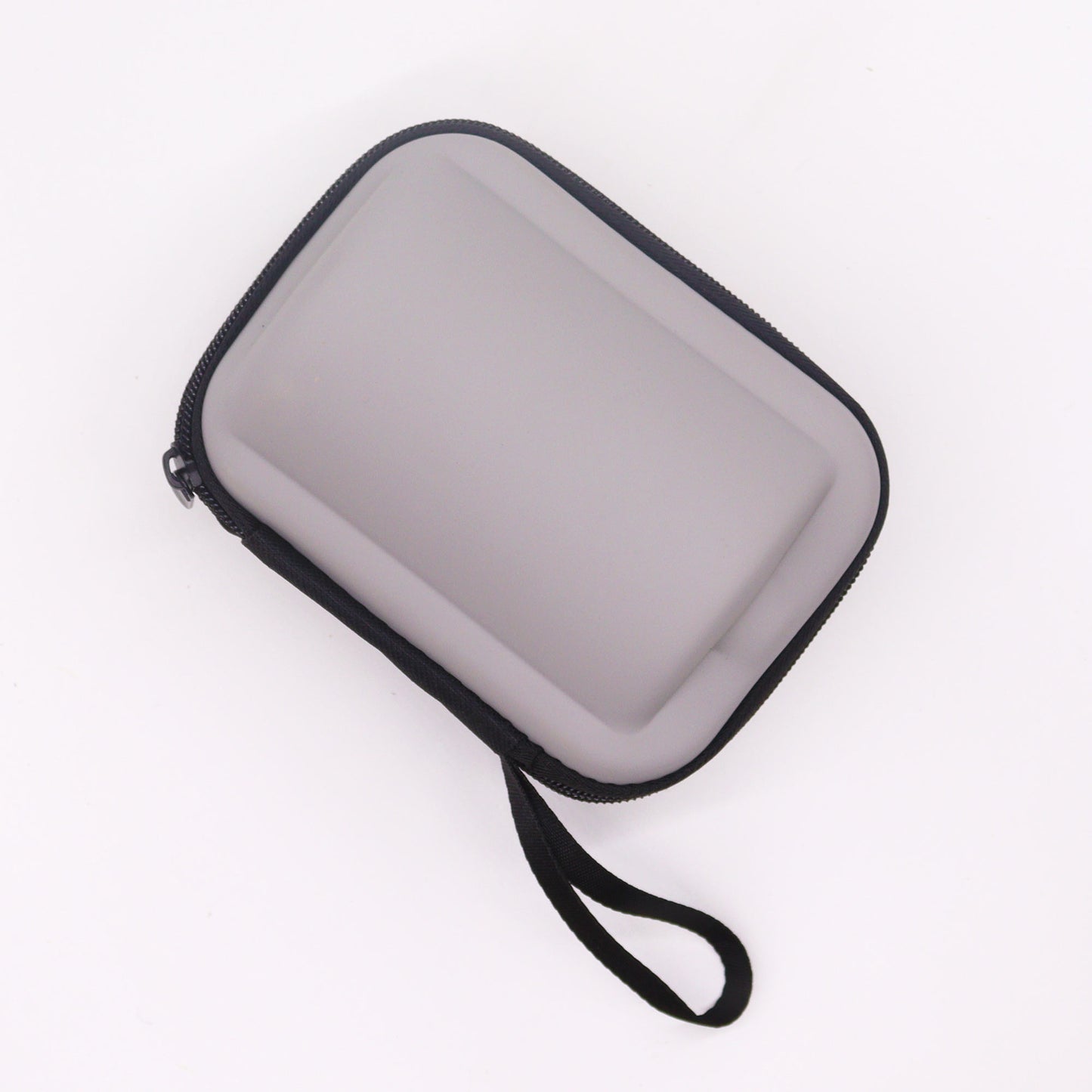 Grey Side of the Zipped Travel Case for the 300ml Mountain Travel Teapot Pouring Tea into one of then4 Cup Set