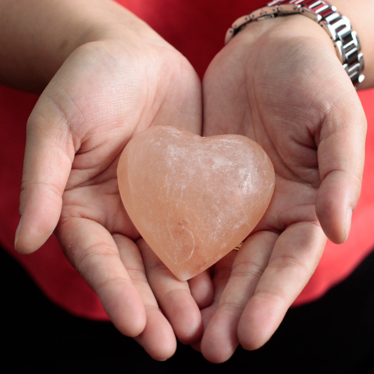 Person Holding a Heart Shaped Himalayan Mineral Salt Deodorant Massage Stone in Her Hands