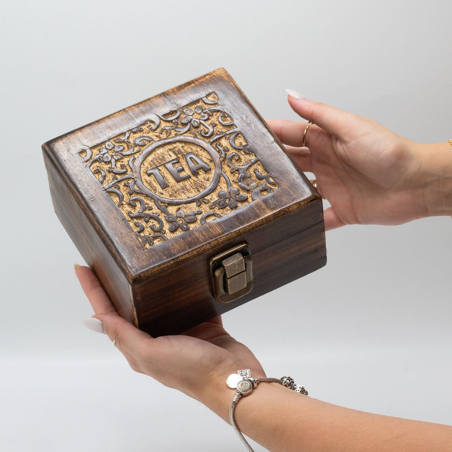 Woman Holding a Mango Wood Vintage Style Carved Tea Box with 4 Compartments