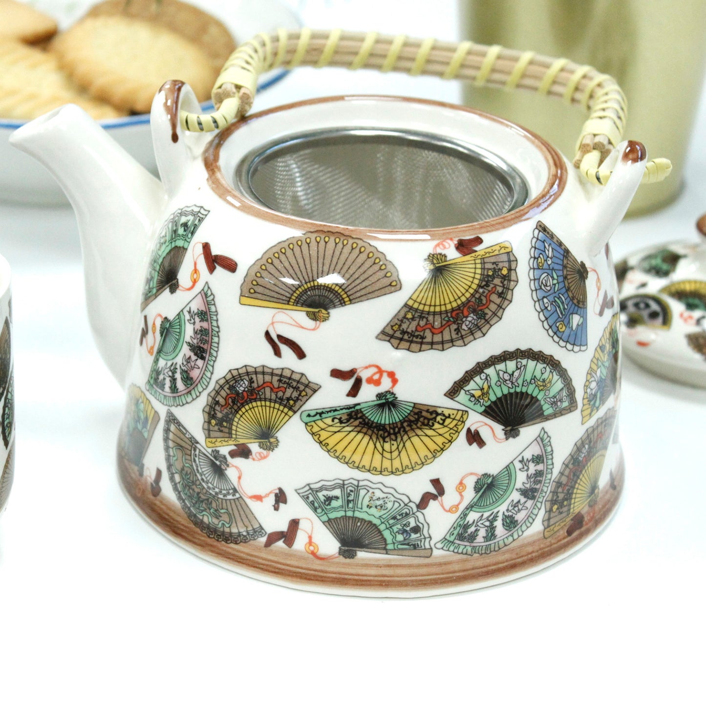 Zoomed in View of the 650ml Chinese Fan Design White Glazed Herbal Teapot and Strainer