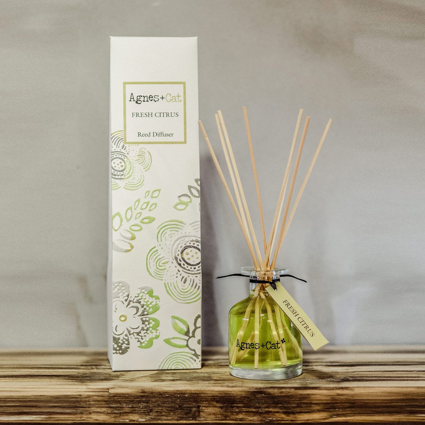 Reed Diffuser - Fresh Citrus - 140ml, green bottle with fanned natural-coloured reeds beside a tall illustrated box by Quintessential Holistic Health Ltd