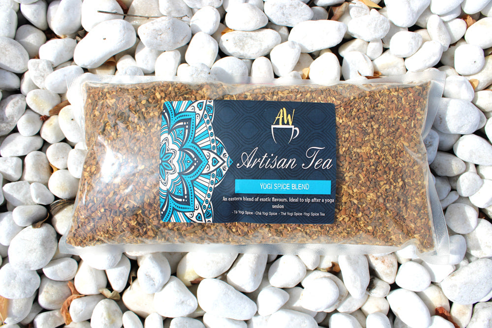 Yogi Spice Blend Artisan Tea - Bagged - 1kg in a clear rectangular bag with a turquoise-accented label among white stones by Quintessential Holistic Health Ltd