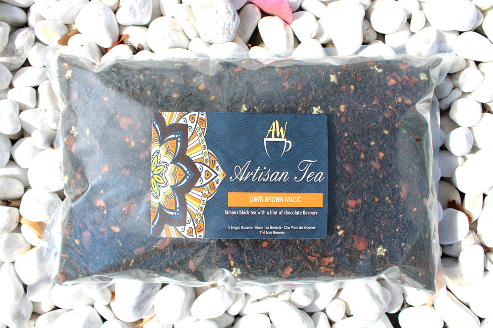 Dark Brown Magic Blend Artisan Tea - Bagged - 1kg in a clear rectangular bag with a dark label among white stones by Quintessential Holistic Health Ltd