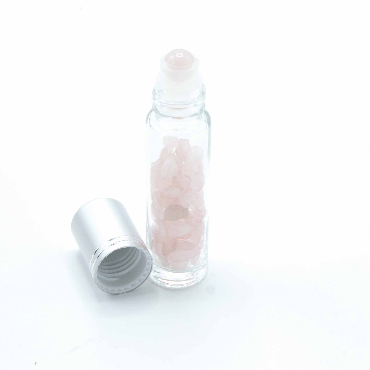 Rose Quartz 10ml gemstone roller bottle with silver cap and visible stone pieces, product detail view from Quintessential Holistic Health.