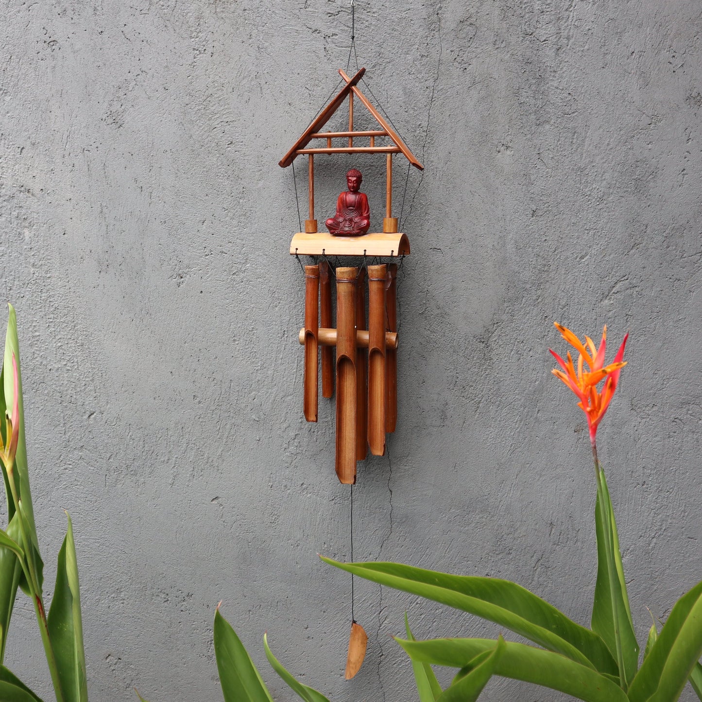 Handcrafted Bamboo Wind Chime - 6 Tubes - Natural & Brown Buddha with a brown Buddha figure beneath a peaked frame by Quintessential Holistic Health Ltd