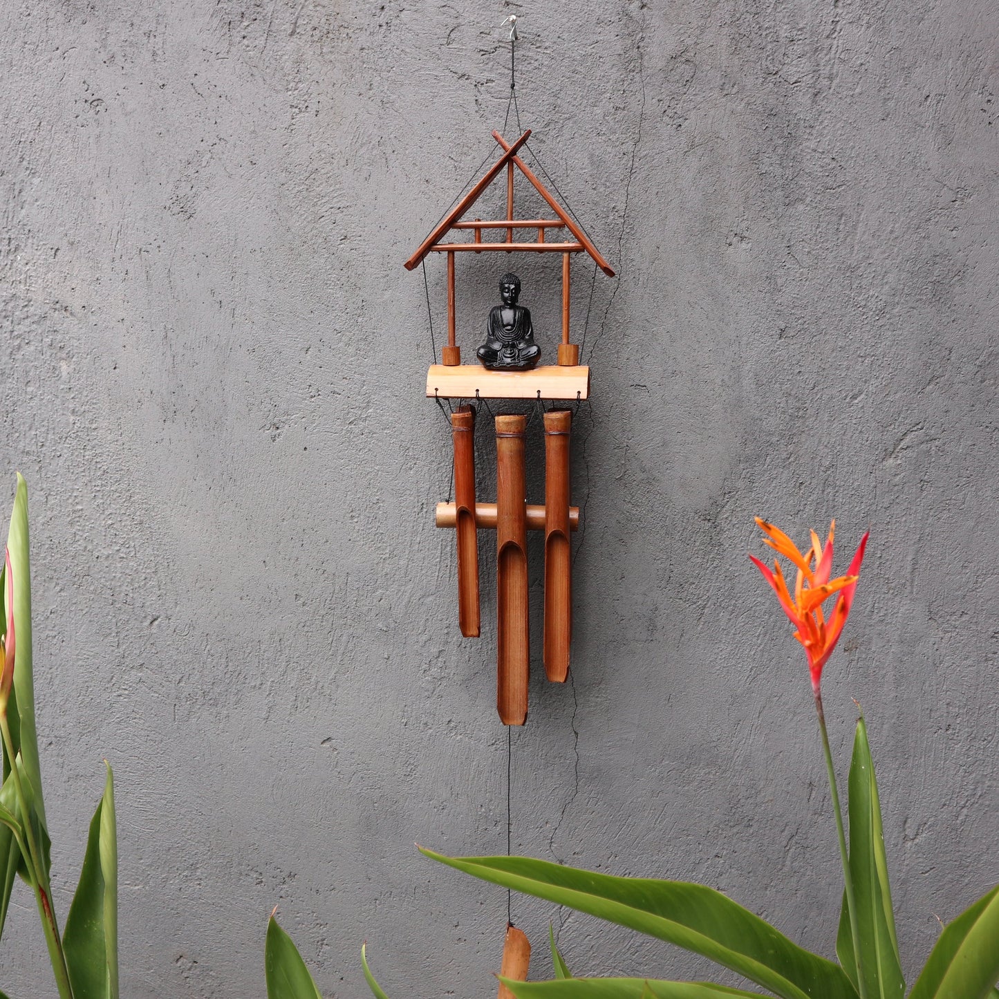 Handcrafted Bamboo Wind Chime - 6 Tubes - Natural & Black Buddha with a dark Buddha figure beneath a peaked frame by Quintessential Holistic Health Ltd