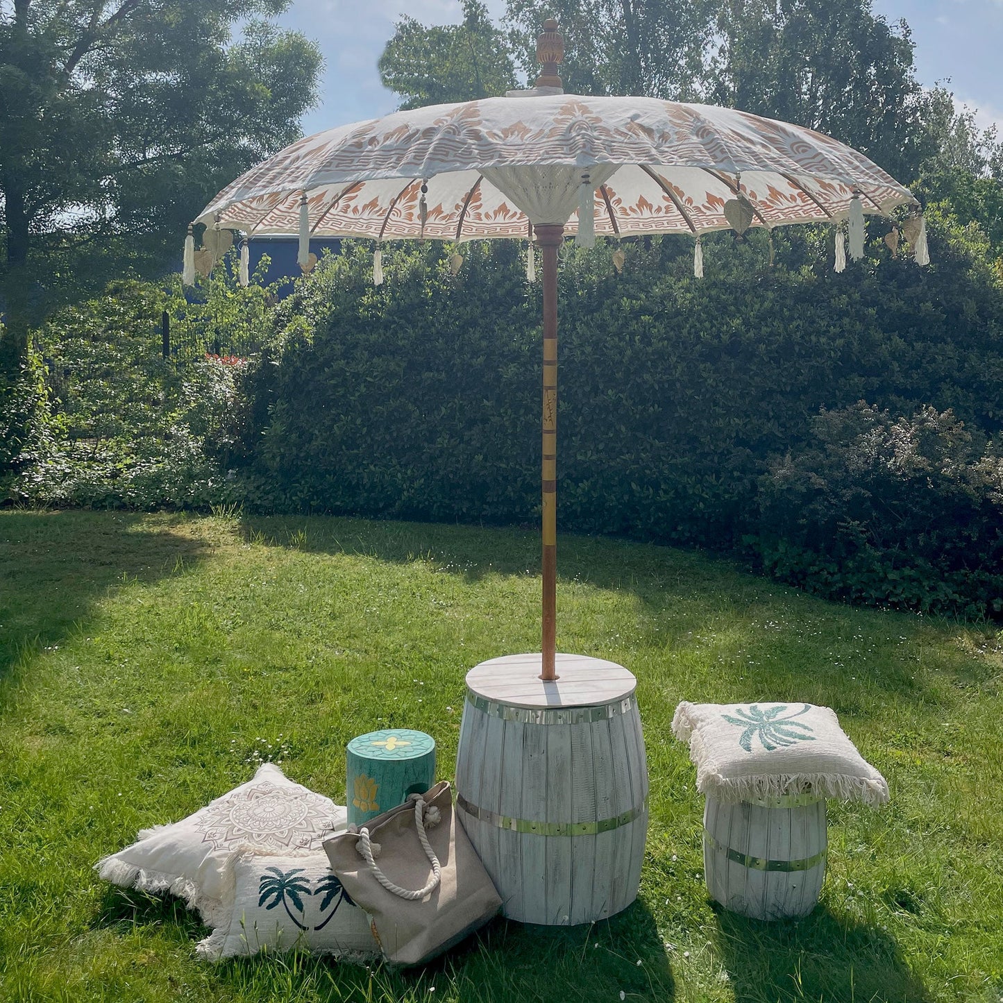 Handcrafted Decorative Parasol - Large - Natural with patterned cream canopy and tasselled edge, standing beside low stools by Quintessential Holistic Health Ltd