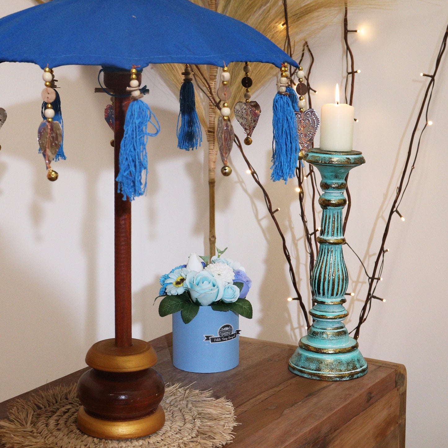 Handcrafted Indoor Parasol with Stand - Small - Plain - Turquoise, open beside a flower pot and tall patterned ornament, by Quintessential Holistic Health Ltd