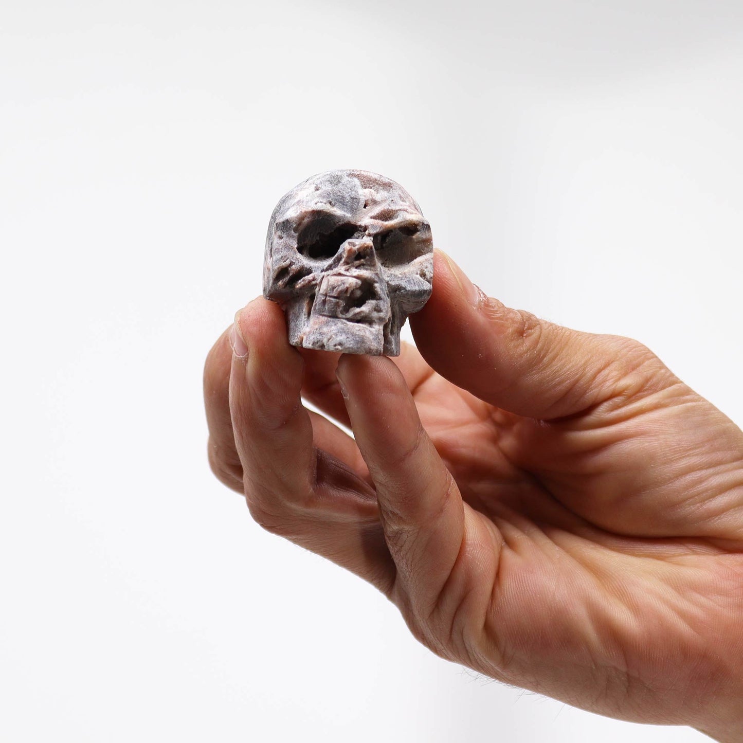 Hand Carved Natural Calcite Skull product packaging on clean background from Quintessential Holistic Health Ltd