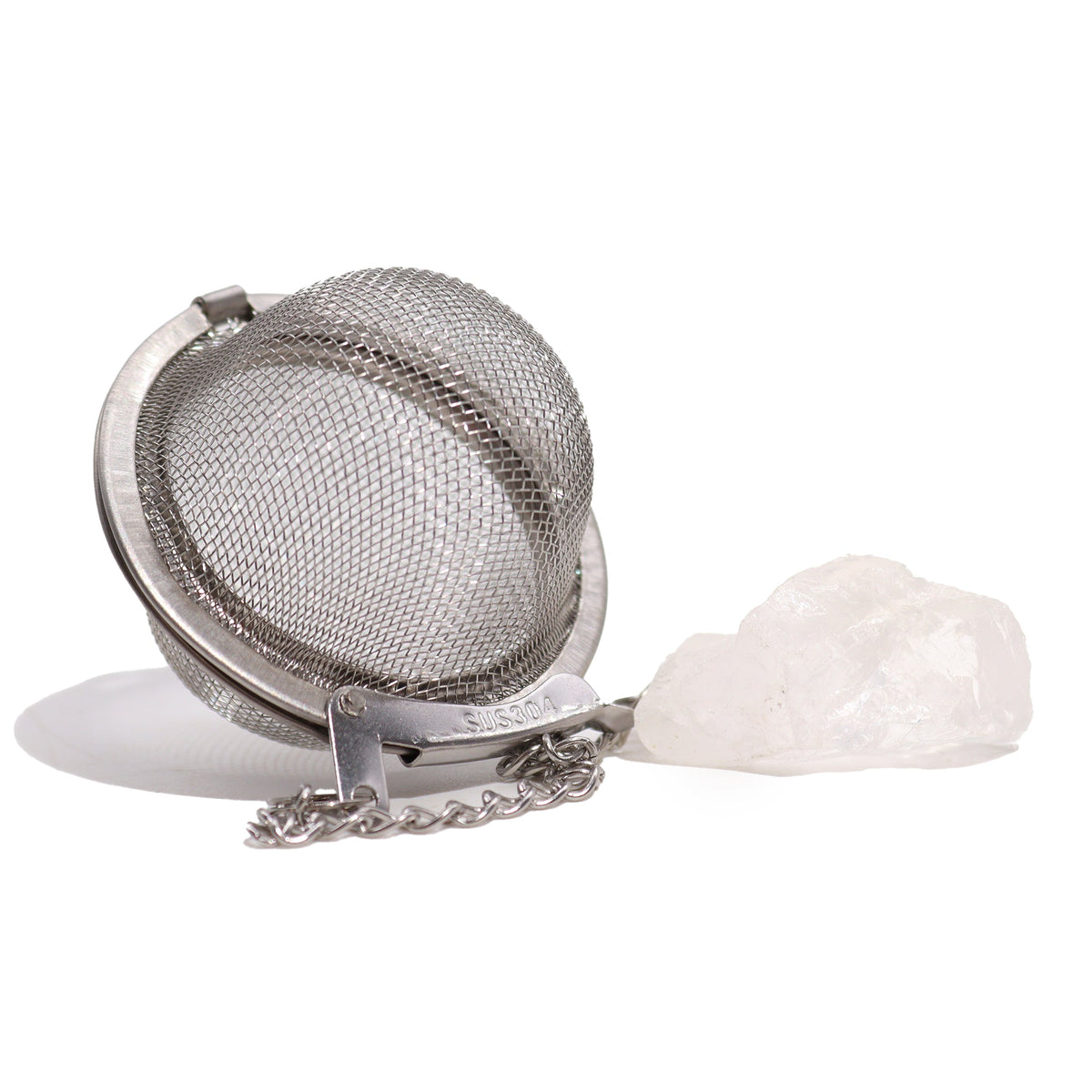 Raw Crystal Gemstone Tea Strainer – Rock Quartz, Balance with an open silver mesh ball beside a large pale translucent stone by Quintessential Holistic Health Ltd