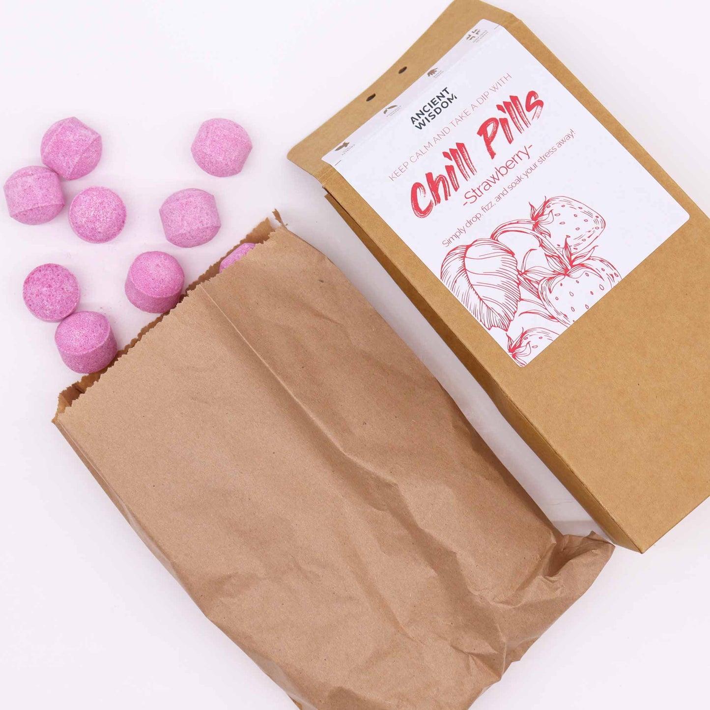 Vegan Bath Bomb Chill Pills Gift Pack - Strawberry - 350g, angled brown box with an open paper bag and scattered purple-pink balls by Quintessential Holistic Health Ltd