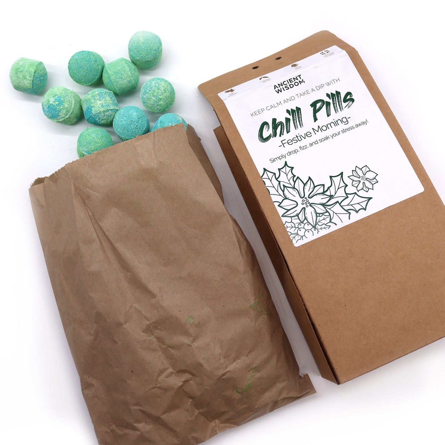 Vegan Bath Bomb Chill Pills Gift Pack - Festive Morning - 350g, open kraft box beside a paper bag and scattered mint-green tablets, by Quintessential Holistic Health Ltd