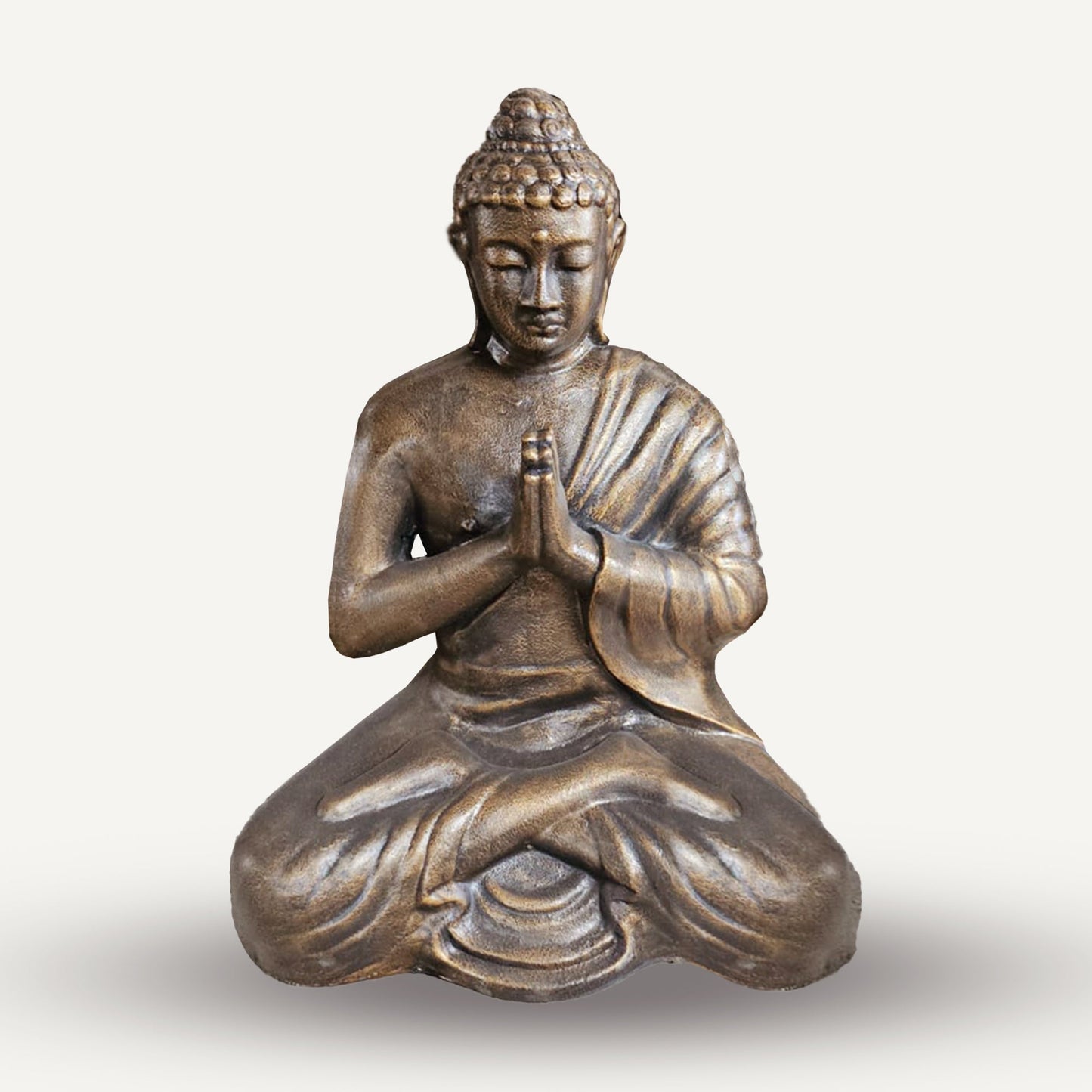 Small 1.2 m Antique Gold Praying Buddha Statue depicting a seated figure with hands together, curled hair and deeply folded robes by Quintessential Holistic Health Ltd