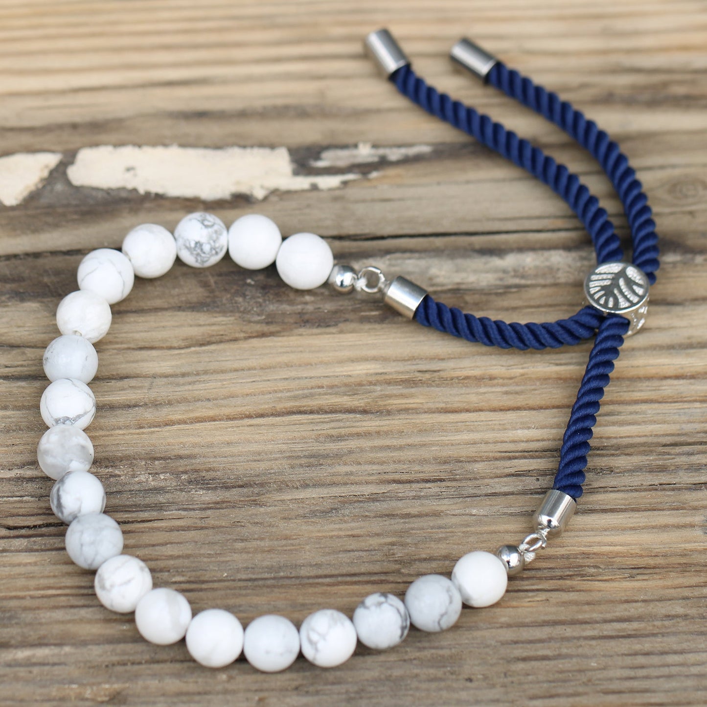 Unisex Handcrafted 925 Silver Plated Gemstone Bracelet - Navy Blue String / White Howlite product packaging on clean background from Quintessential Holistic Health Ltd