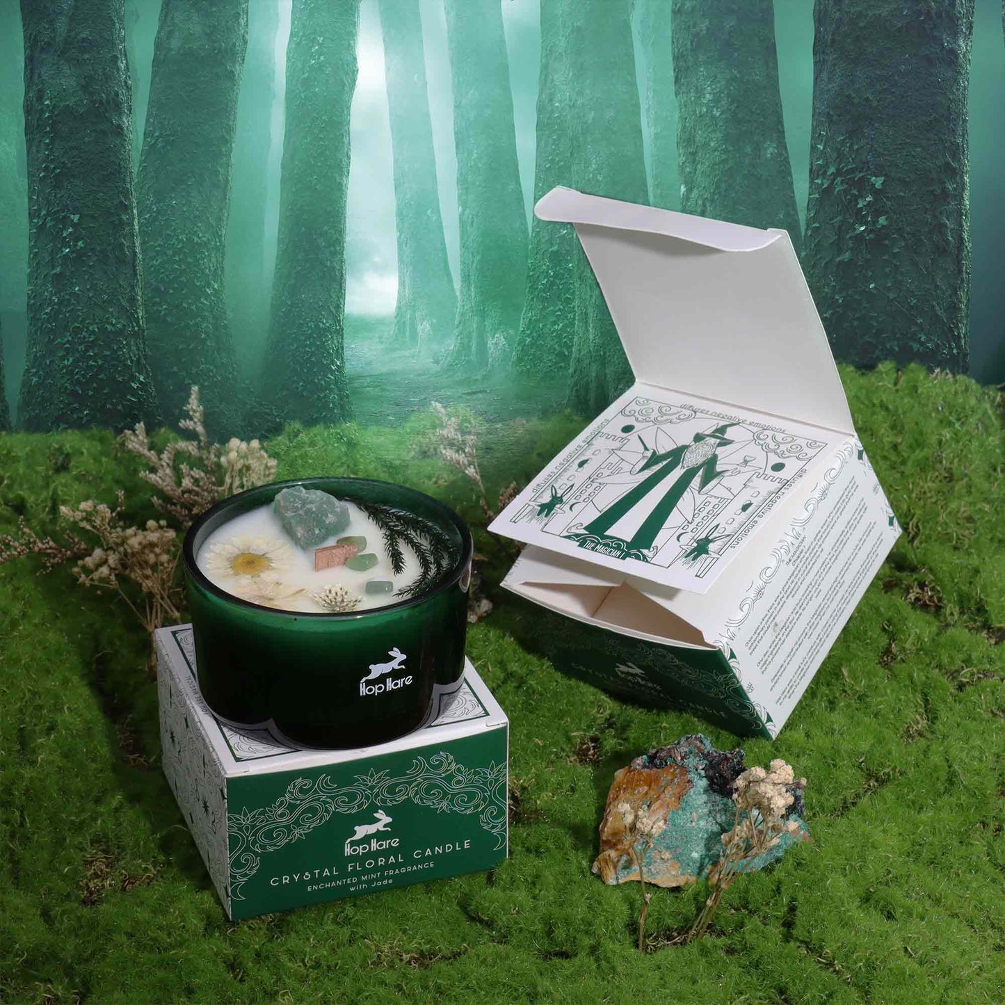 Eco-Friendly Soy Wax Candle - The Magician beside an open illustrated box amid moss and trees by Quintessential Holistic Health Ltd