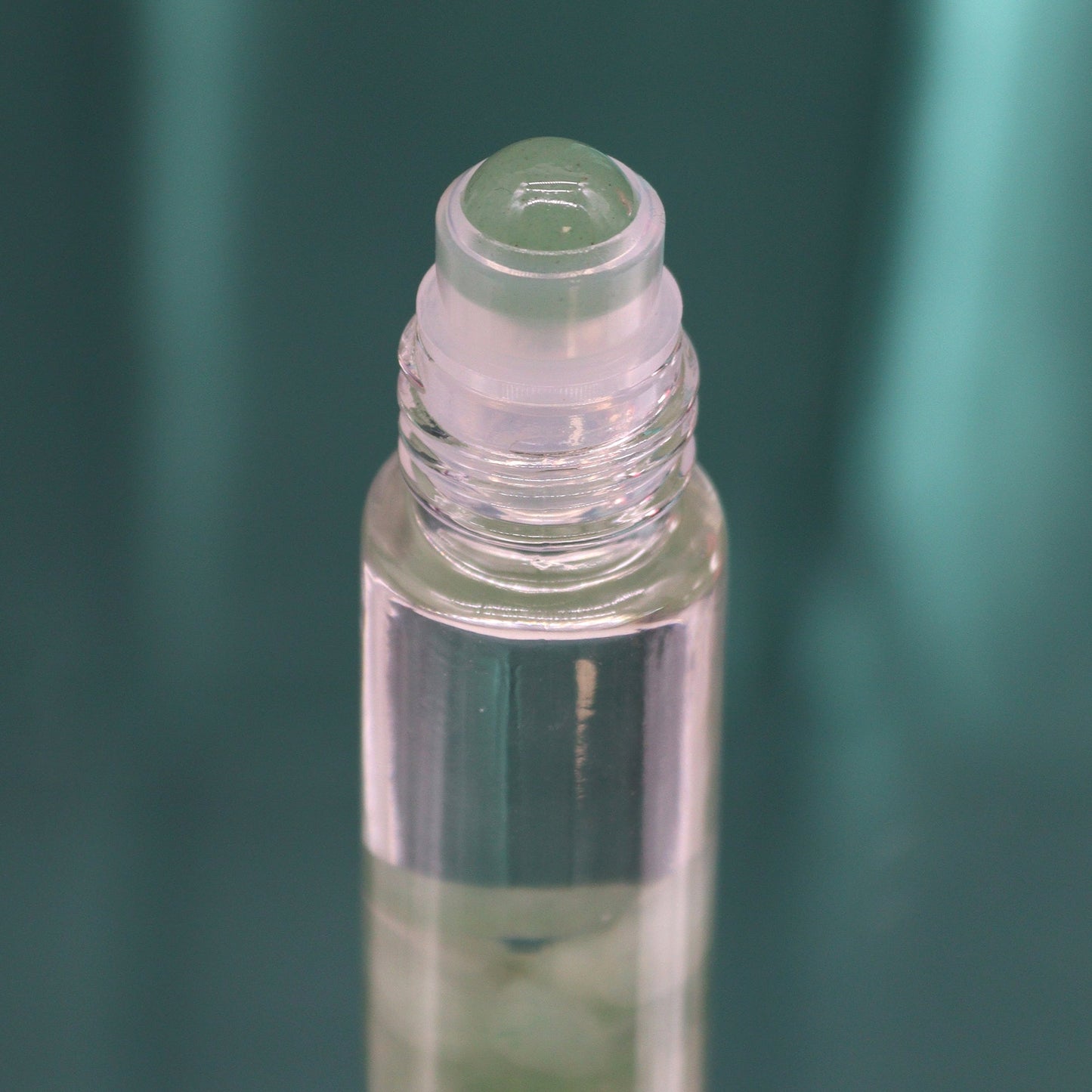 Gemstone Tarot Oil Roll-On - Green Aventurine - The Magician showing the clear roller top above pale green stones by Quintessential Holistic Health Ltd