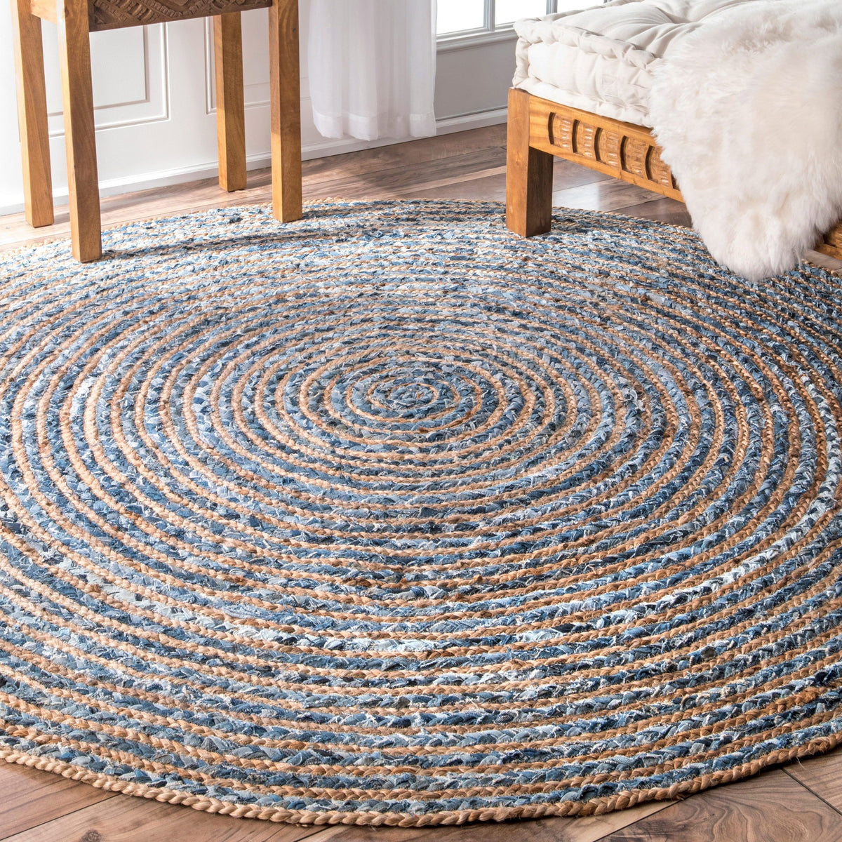 Handmade Round Jute and Recycled Denim Rug - 150 cm, blue and natural rings extending beneath a chair and bed, by Quintessential Holistic Health Ltd