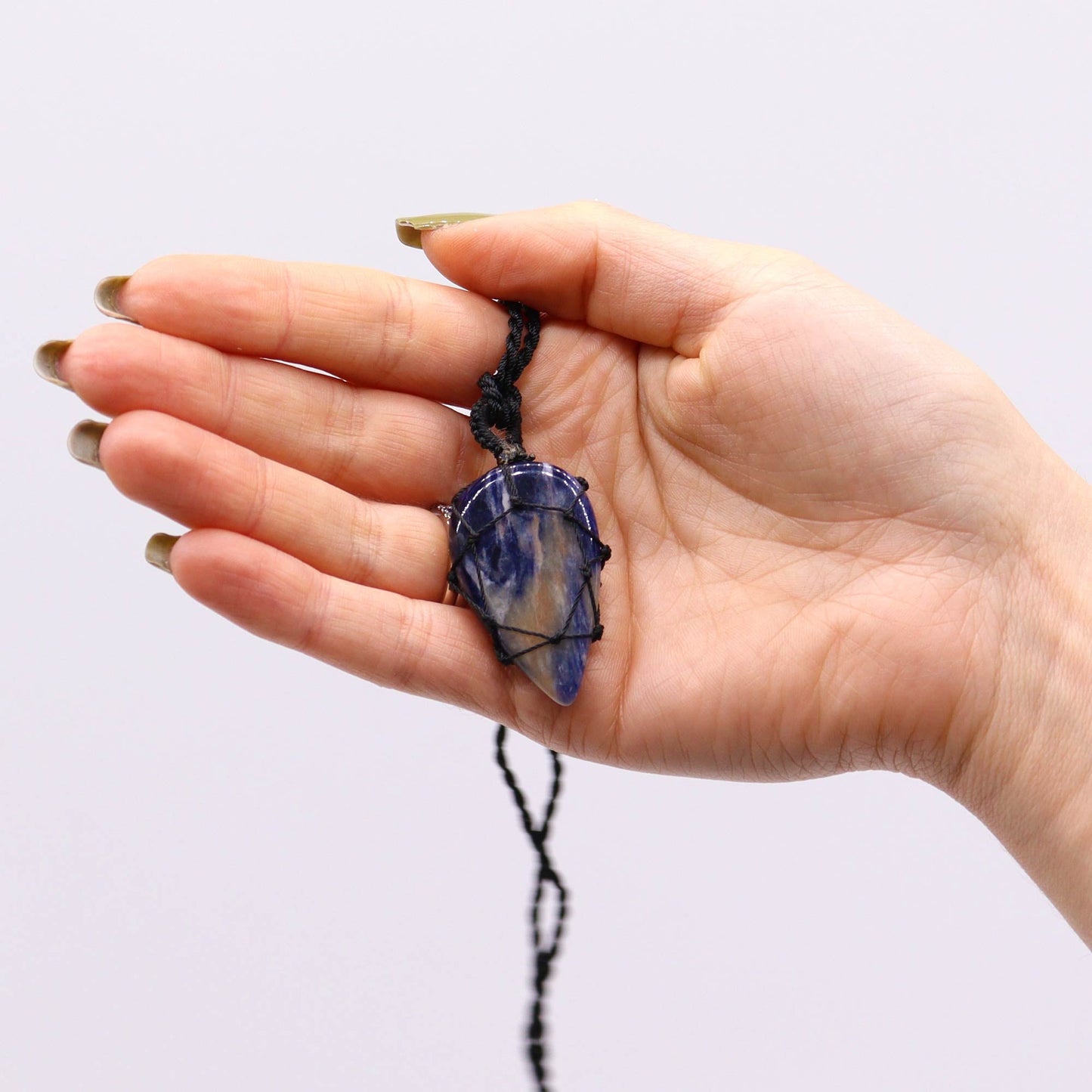Handmade Laced Gemstone Pendant - Teardrop / Sodalite product packaging on clean background from Quintessential Holistic Health Ltd