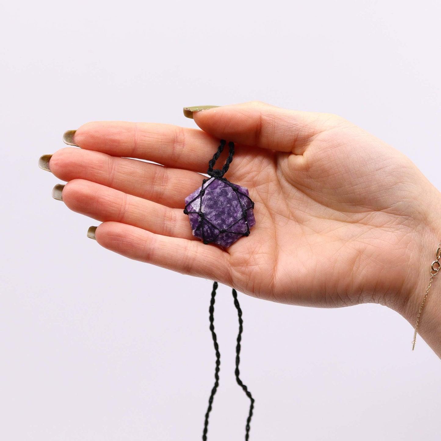 Handmade Laced Gemstone Pendant - Hexagonal / Lepidolite product packaging on clean background from Quintessential Holistic Health Ltd