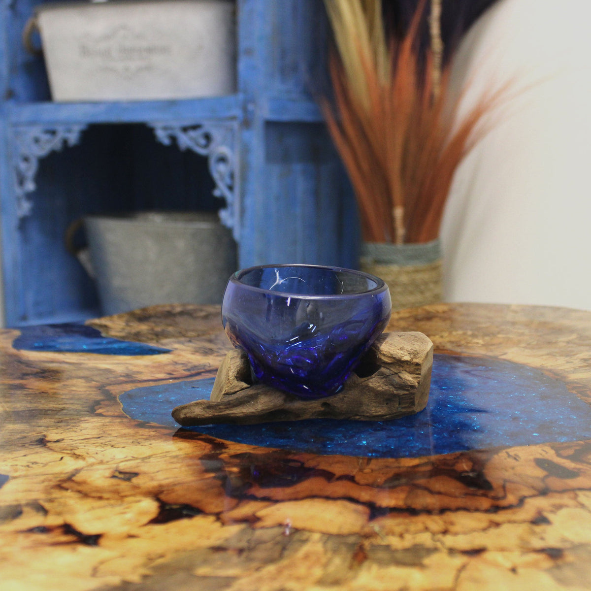 Recycled Glass Vase on Wood - Clear Round Blue with a glossy dark-blue bowl on a low rustic wood base by Quintessential Holistic Health Ltd
