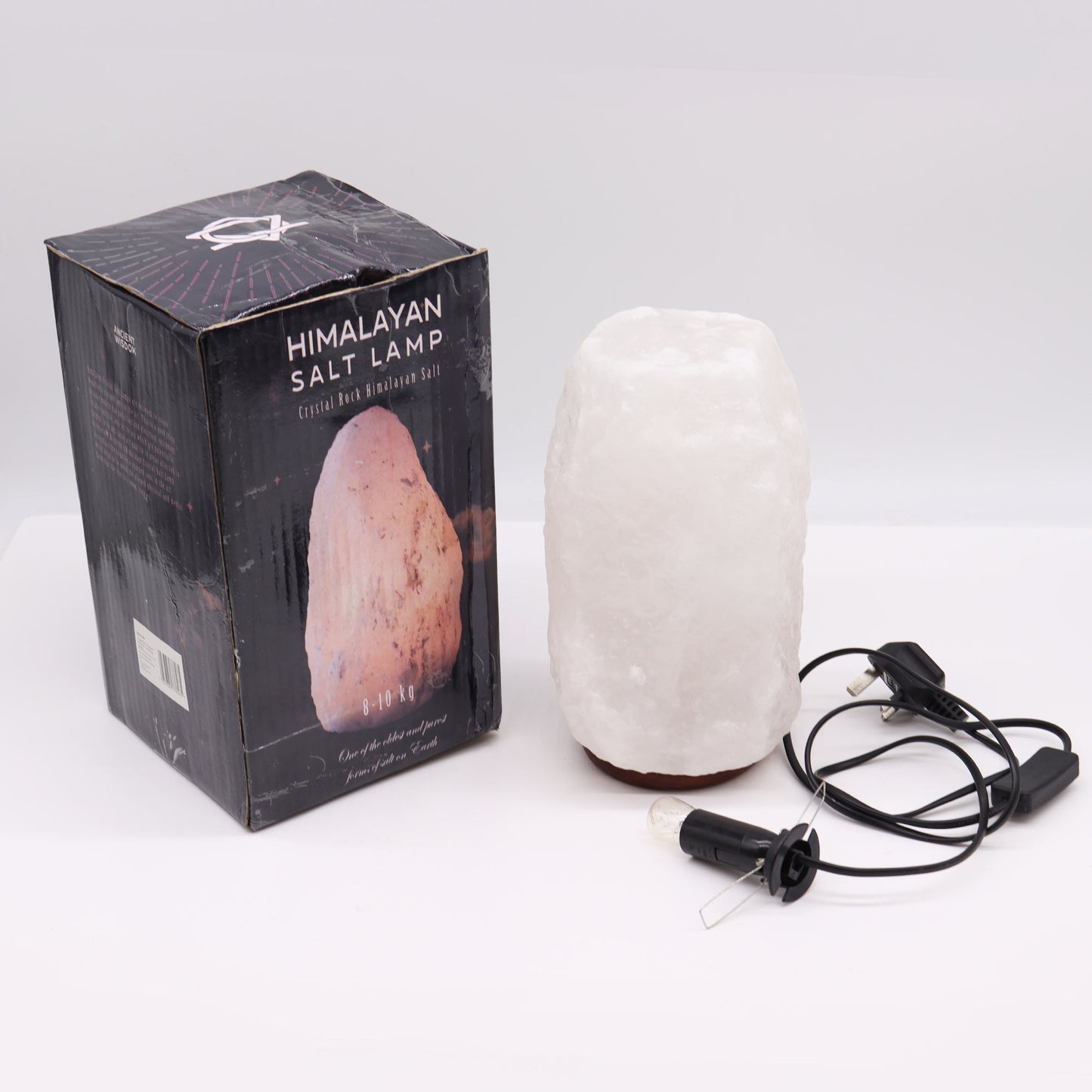 240V Himalayan Salt Crystal Lamp & Base - White/Natural - 8–10kg, lamp beside a black branded box, cable and bulb holder by Quintessential Holistic Health Ltd