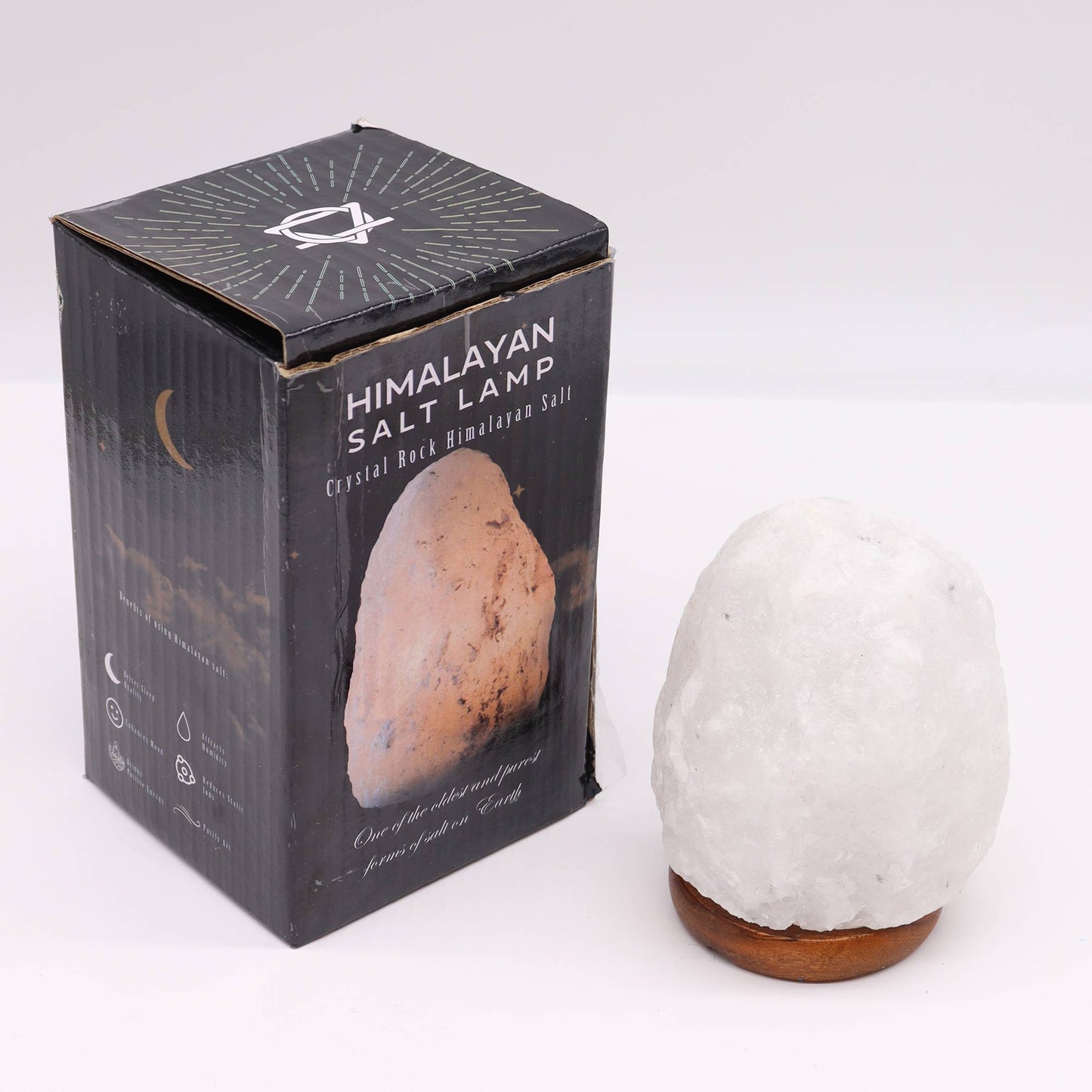 240V Himalayan Salt Crystal Lamp & Base - White/Natural - 1.5–2kg beside a black Himalayan salt lamp box by Quintessential Holistic Health Ltd