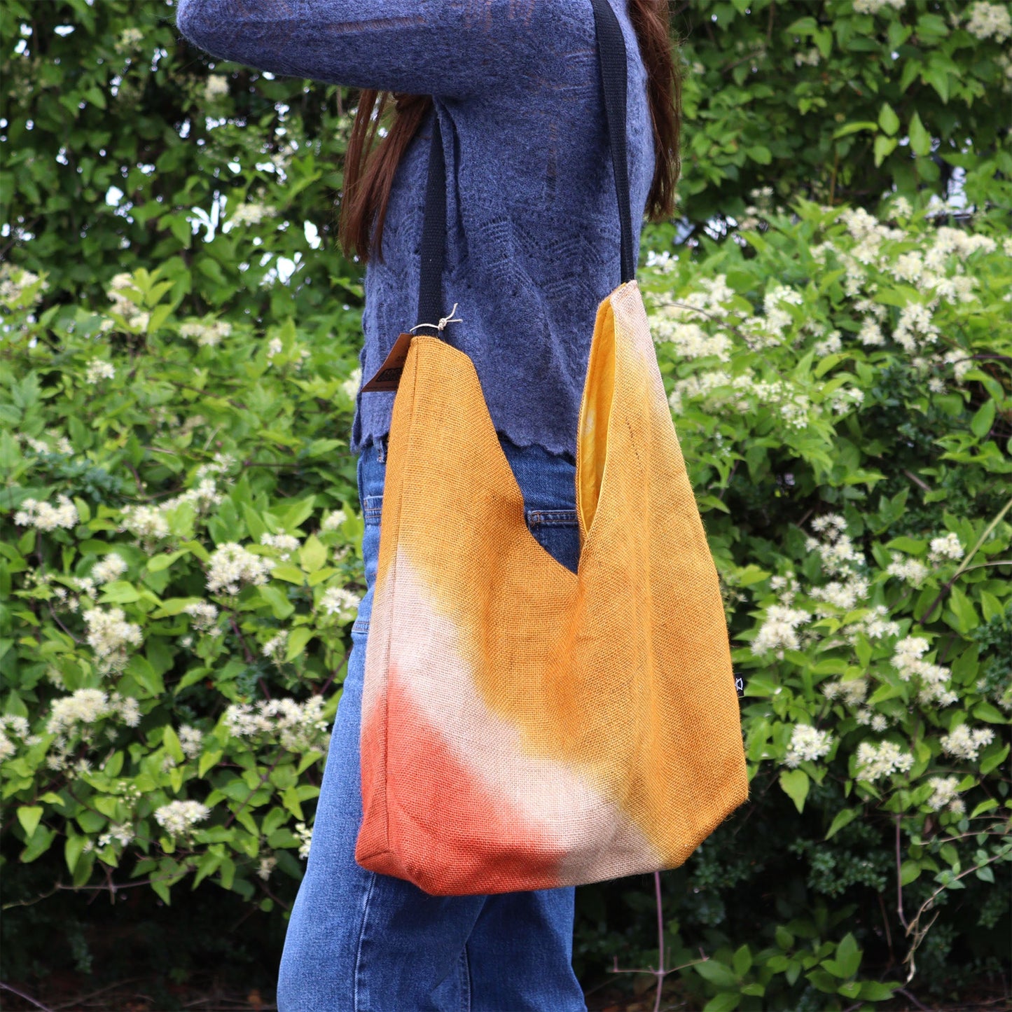 Jute and Cotton Shoulder Tote Bag - Turmeric worn over the shoulder with the orange and cream lower panels visible by Quintessential Holistic Health Ltd