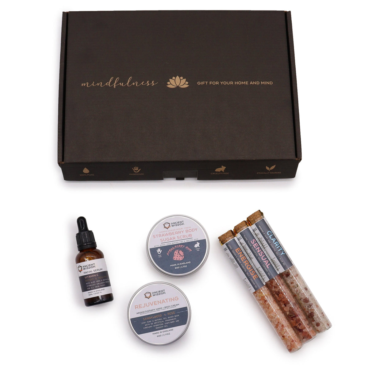 Serenity self-care kit, two round tins and three tubes displayed below a dark presentation box from Quintessential Holistic Health.
