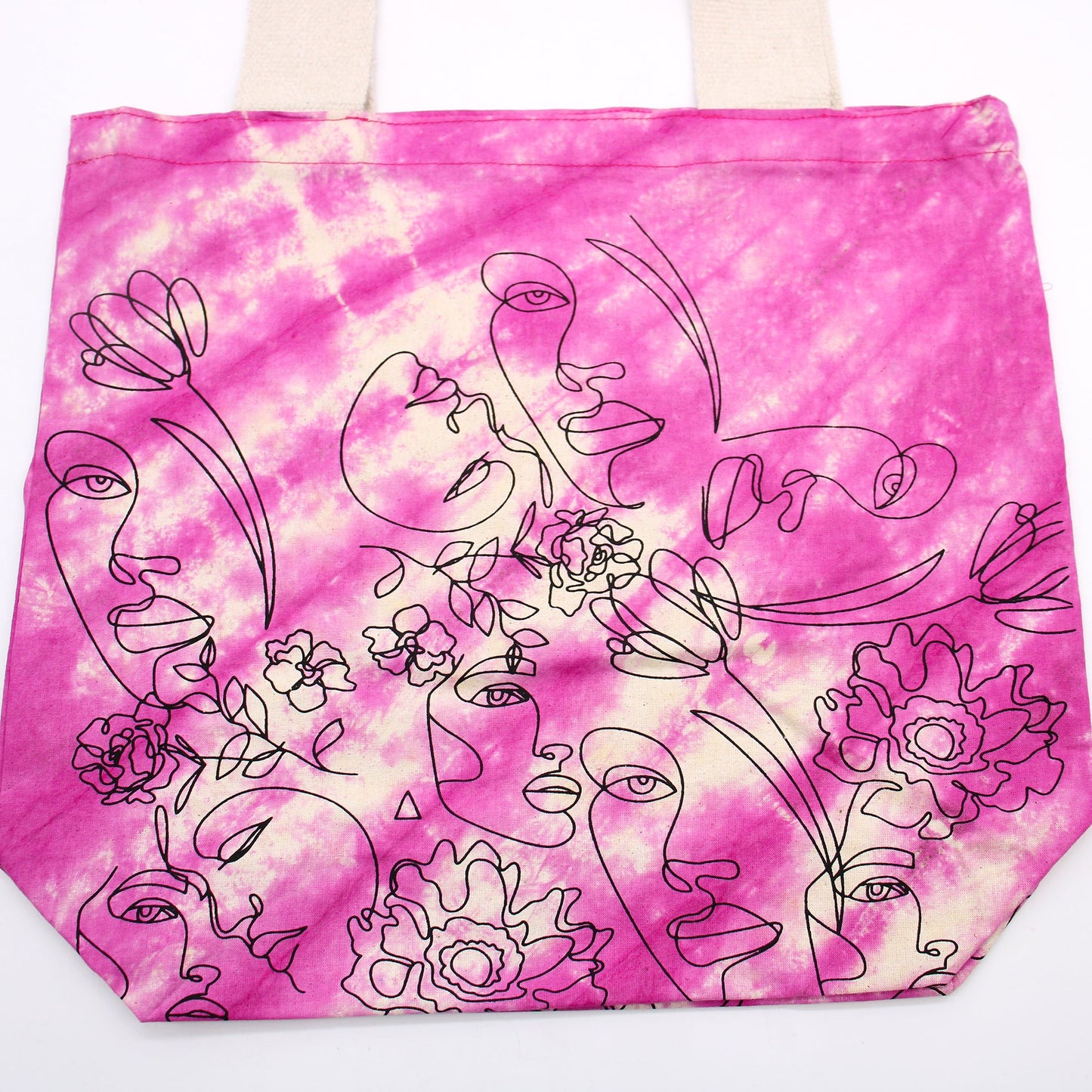 Tie-Dyed Cotton Tote Bag - Pretty Face - Pink with white tie-dye streaks and a dense black faces-and-flowers design by Quintessential Holistic Health Ltd