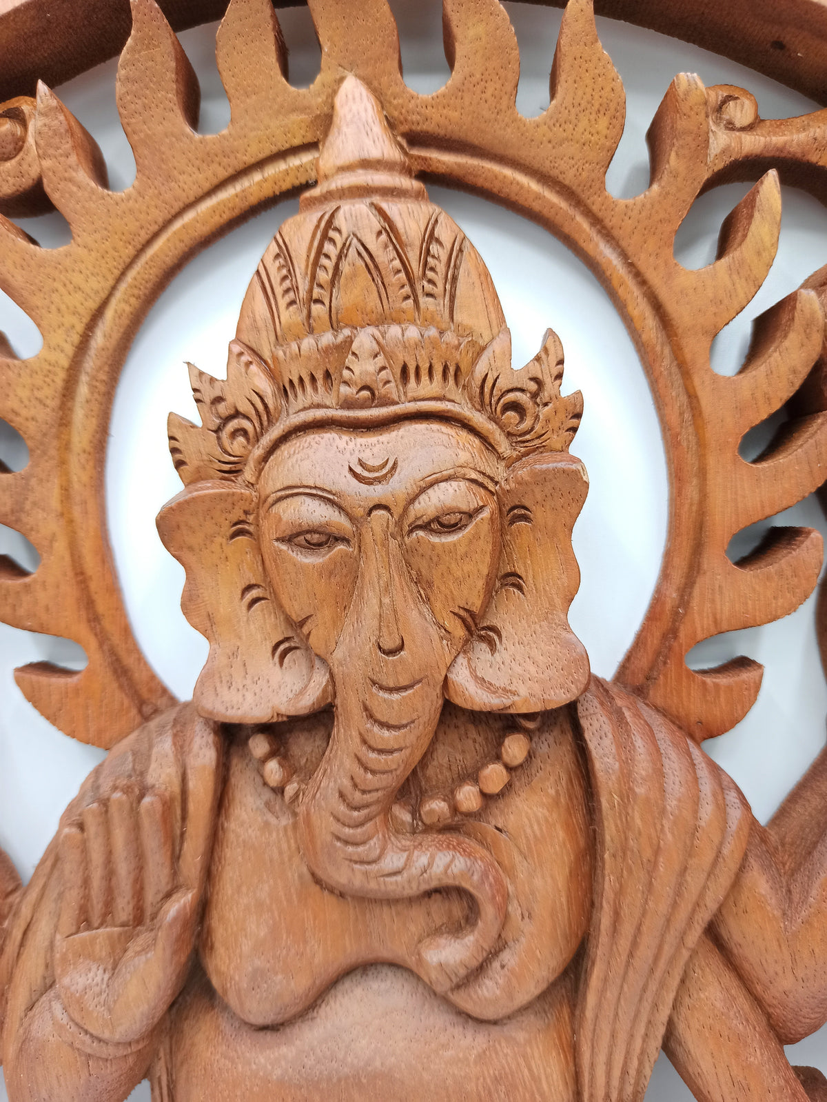Ganesh - 40cm - Handmade Decorative Suar Wood Plaque showing the carved face, ornate crown, curved trunk and raised hand by Quintessential Holistic Health Ltd