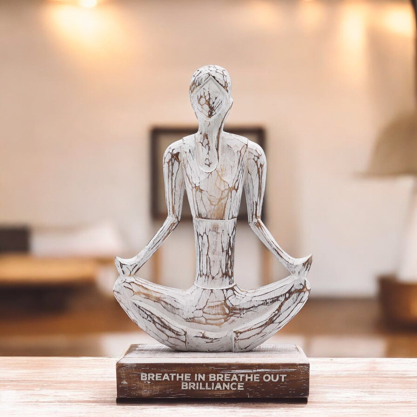 Albasia Wood Yoga Lady - Easy Pose - Brilliance - Whitewash displayed on a wooden table in a softly lit room by Quintessential Holistic Health Ltd