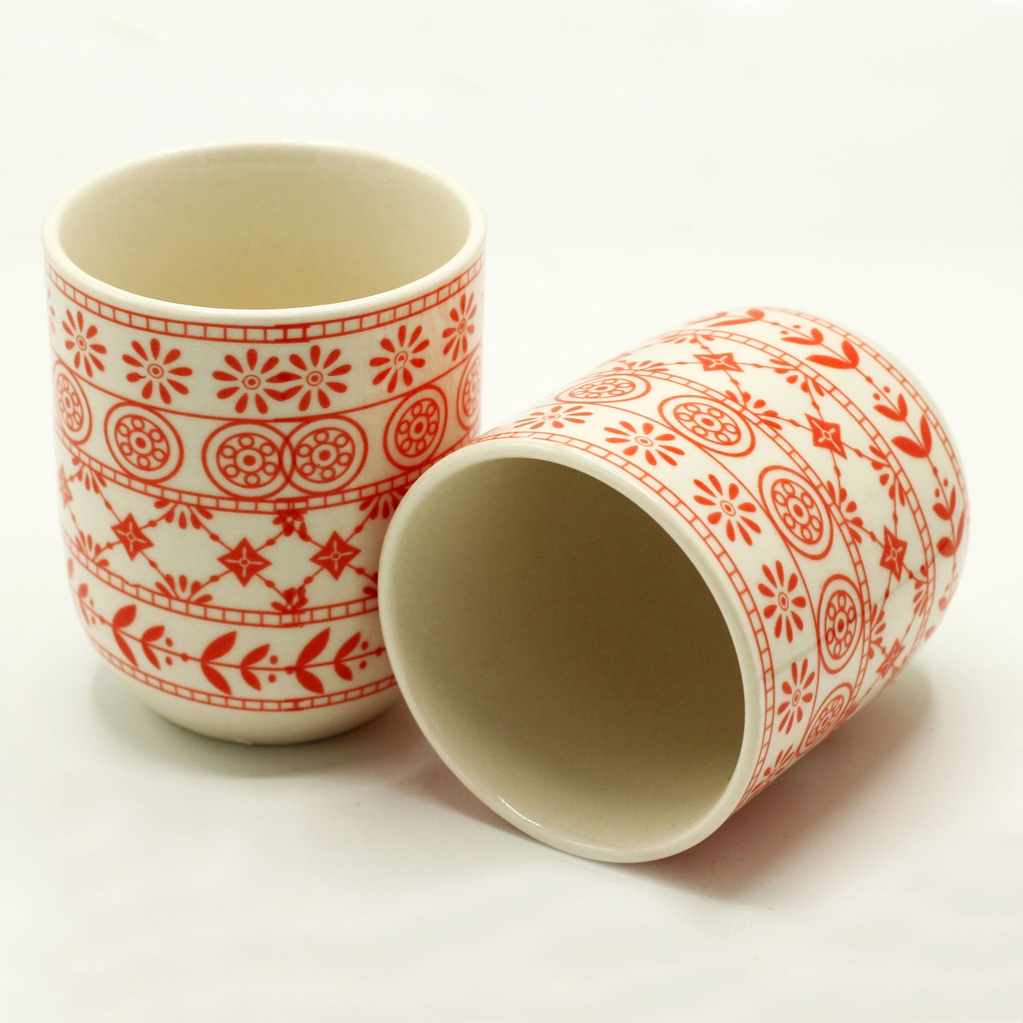 2 Ceramic Amber Tea Cups with One Lying Down