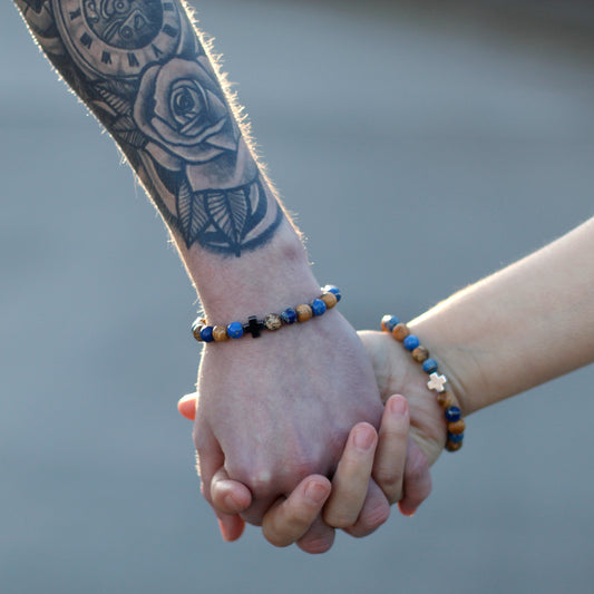 2 People Holding Hands Wearing Partner or Love or Friendship Gemstone Bracelets