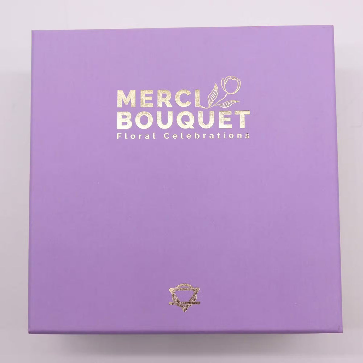 Luxury Soap Flowers - Square - Blues, in a closed purple box with gold Merci Bouquet branding, by Quintessential Holistic Health Ltd