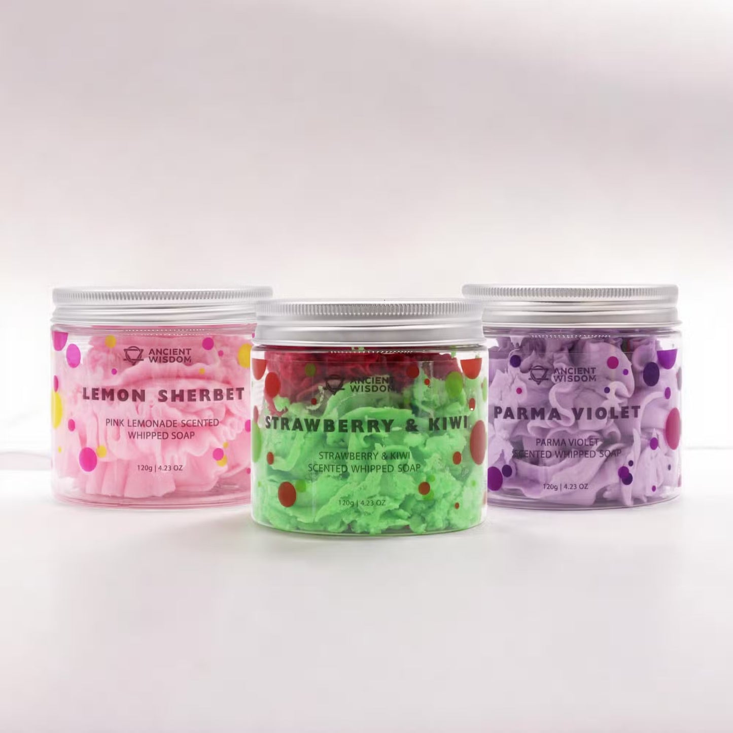 3 Whipped Soaps: Lemon Sherbet, Strawberry and Kiwi & Parma Violet, three clear tubs of pink, green and purple whipped soap by Quintessential Holistic Health Ltd