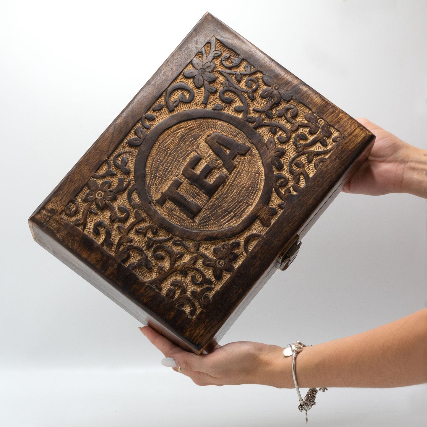 Woman Holding a Mango Wood Vintage Style Carved Tea Box with 12 Compartments