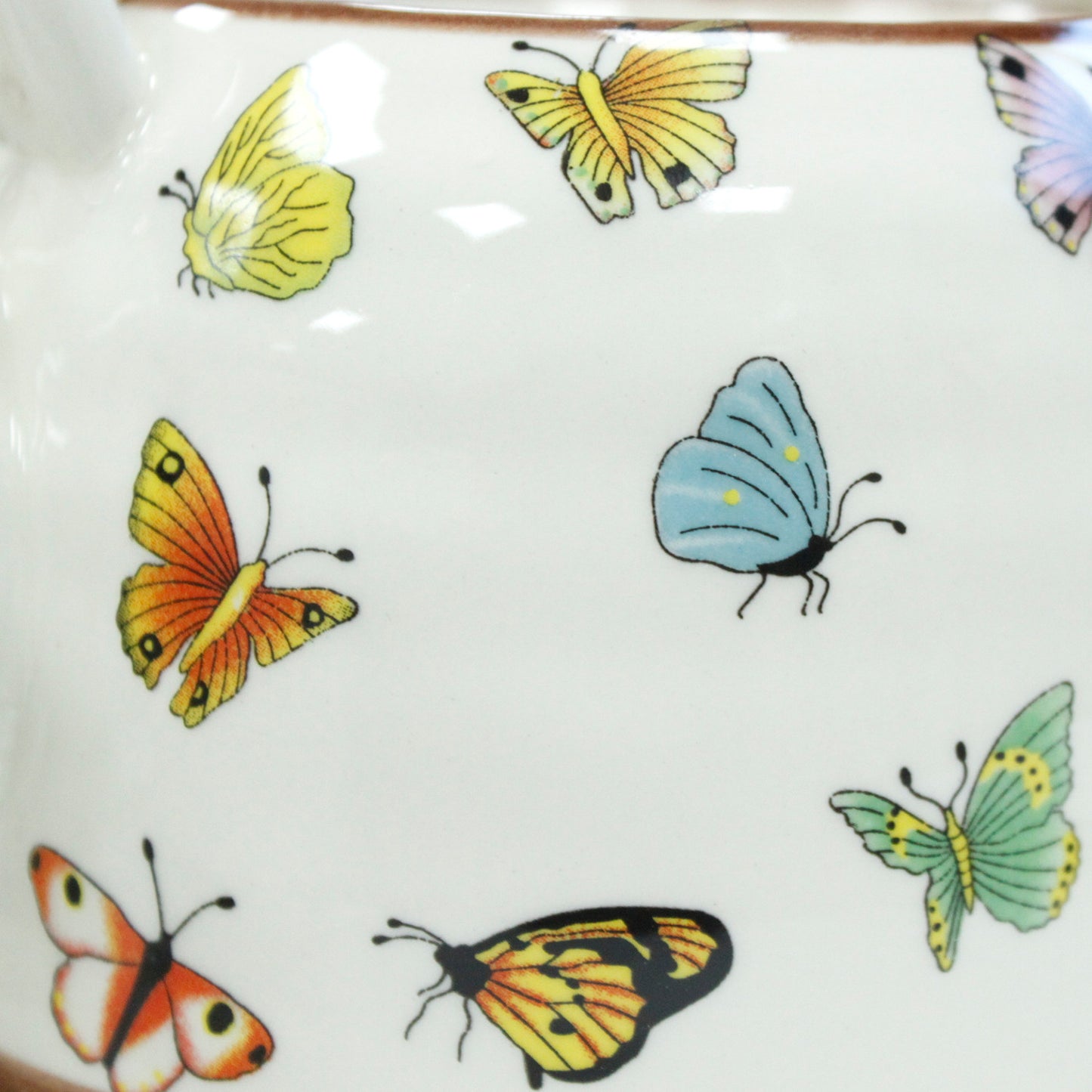 Zoomed In View of the 650ml Butterflies Design White Glazed Herbal Teapot