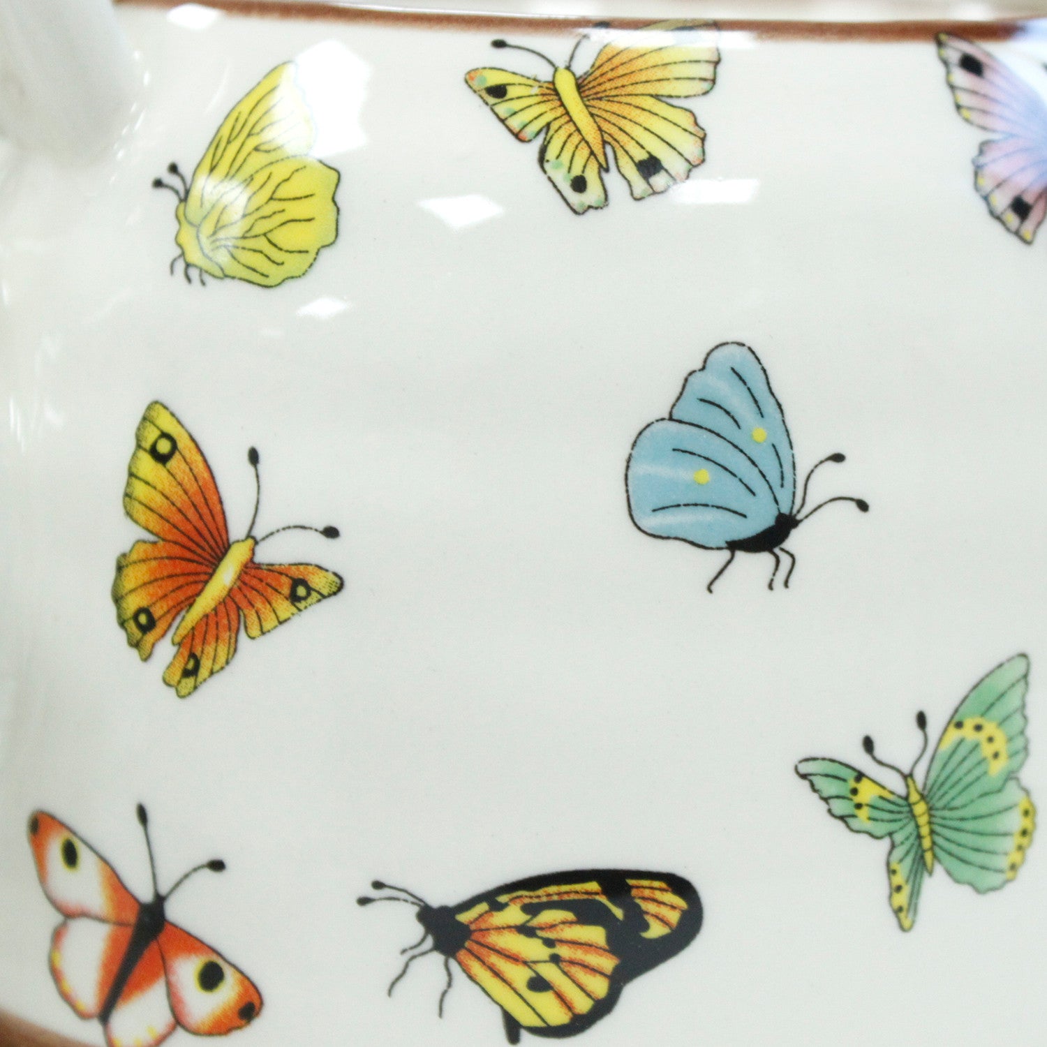 Zoomed In View of the 650ml Butterflies Design White Glazed Herbal Teapot