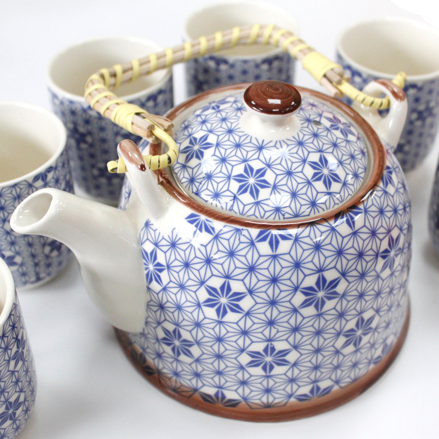 Zoomed in on the 650ml Blue Star Design White Ceramic Herbal Teapot with a Strainer and a 6 Matching Cup Set