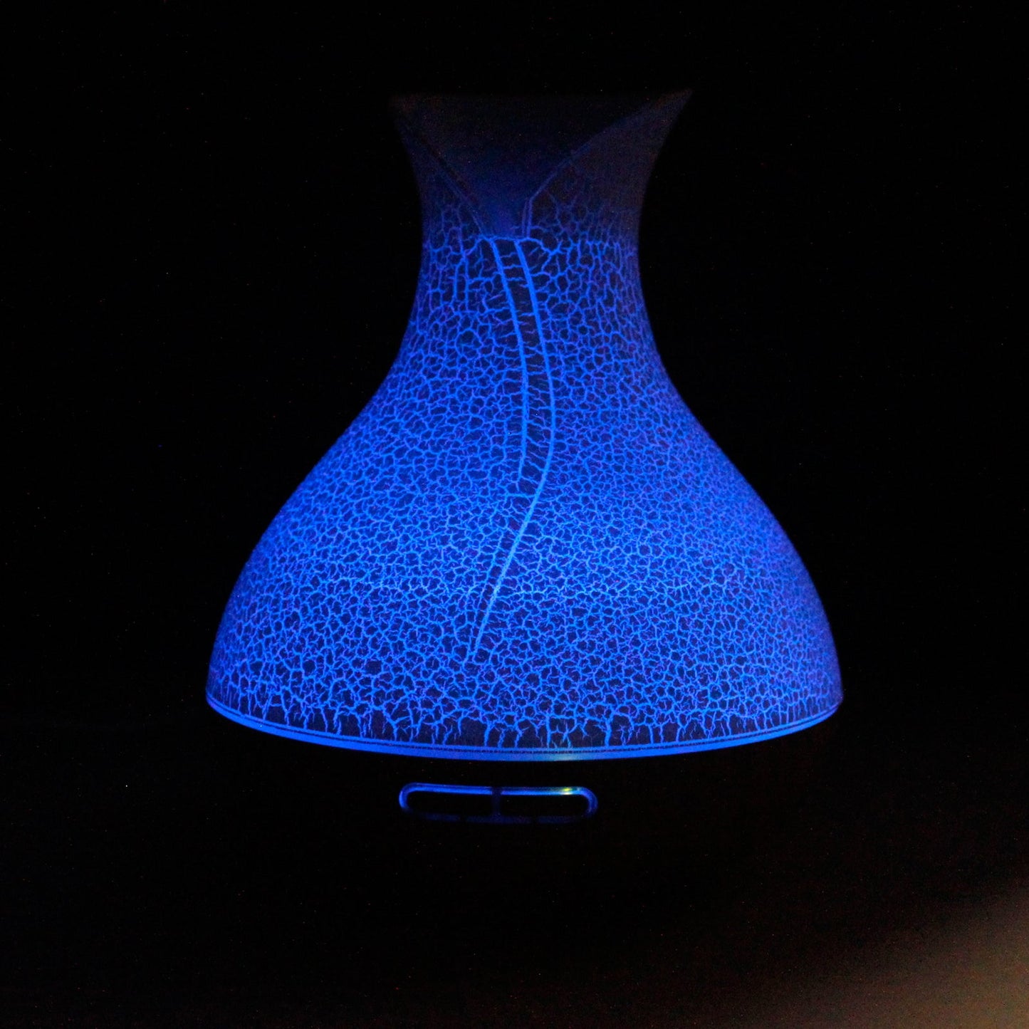 Colour-Changing USB Aroma Diffuser - Palma Shell, crackle-patterned curved design glowing blue against black, by Quintessential Holistic Health Ltd