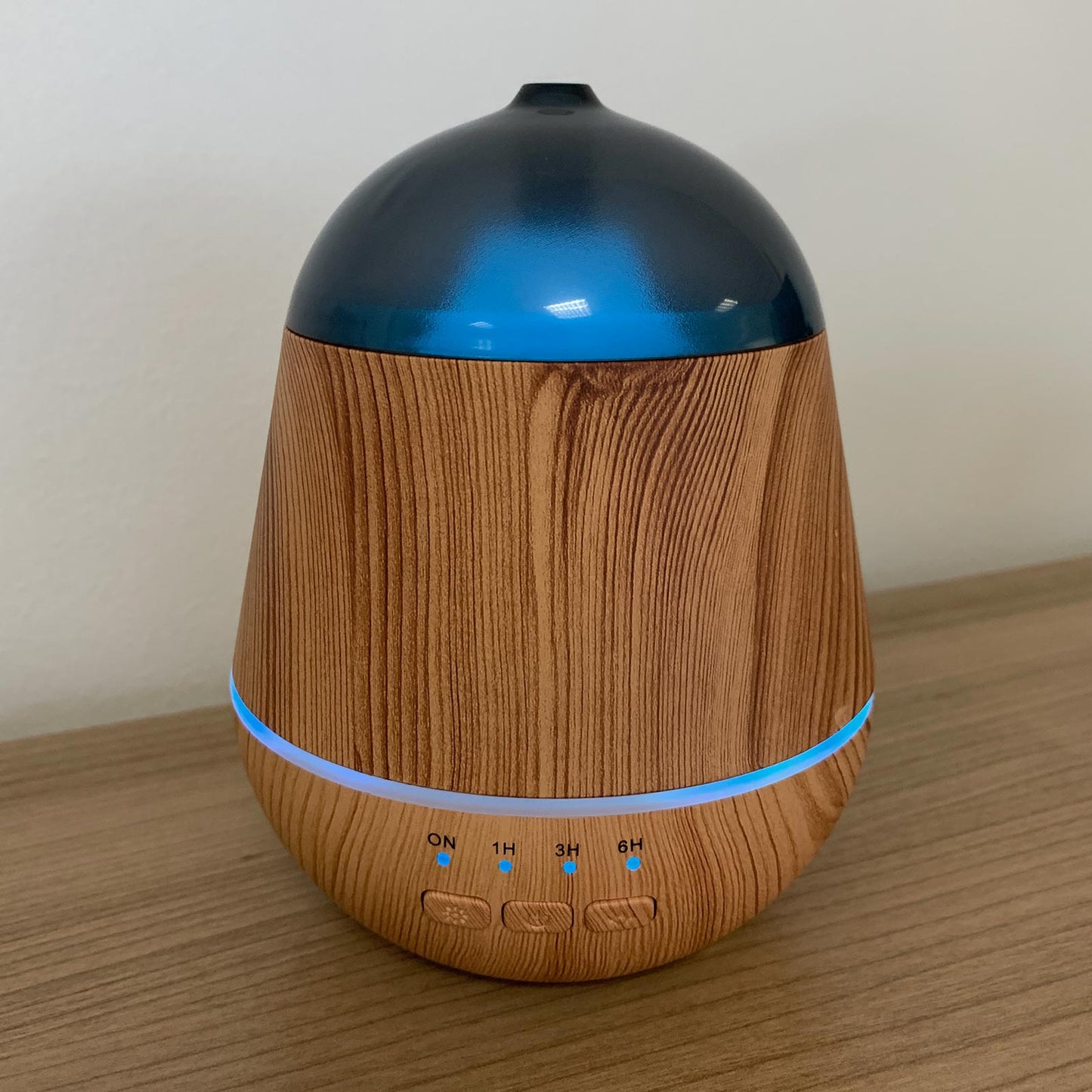 Colour-Changing USB Aroma Diffuser - Marseille with a wood-grain body, blue-lit domed top, glowing blue band and four buttons by Quintessential Holistic Health Ltd