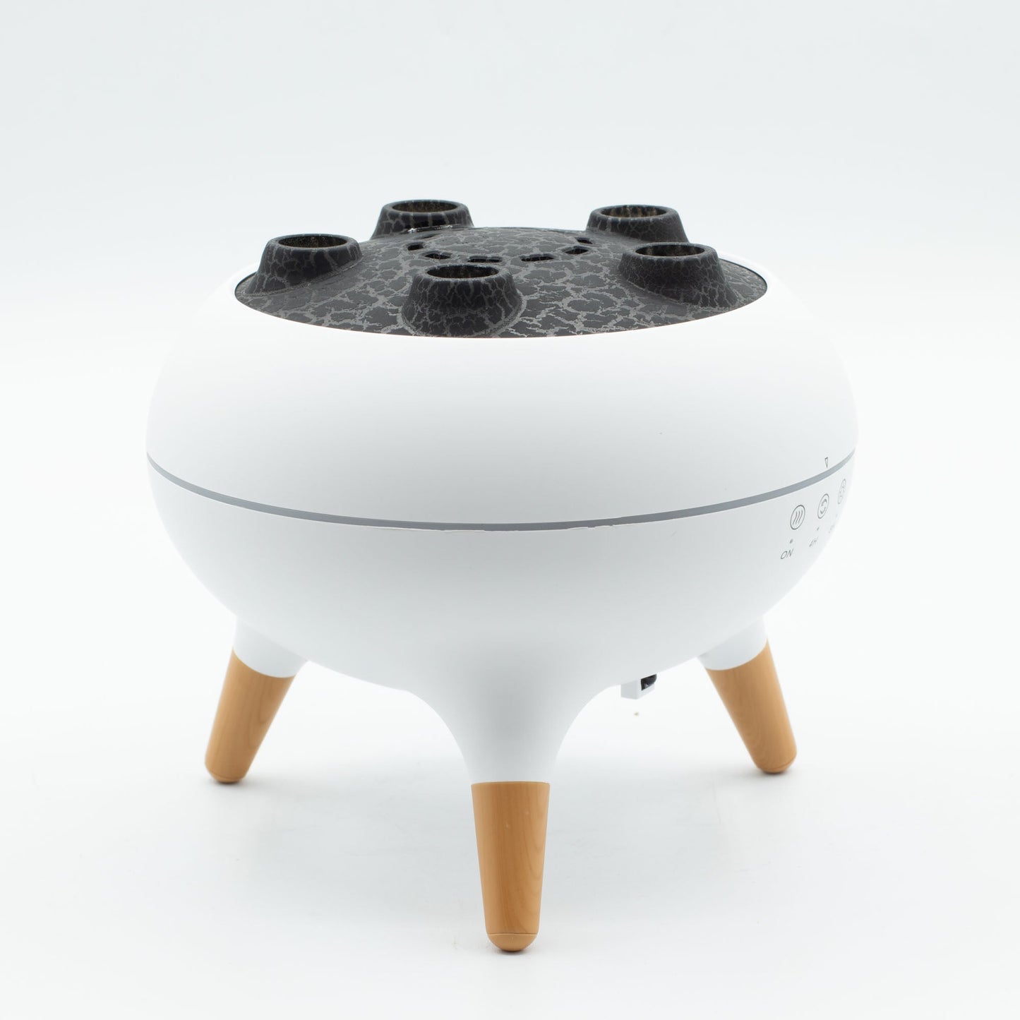Colour-Changing USB Jellyfish Puff-Effect Aroma Diffuser with Remote, with a white bowl-shaped body, dark perforated top and three tan legs by Quintessential Holistic Health Ltd