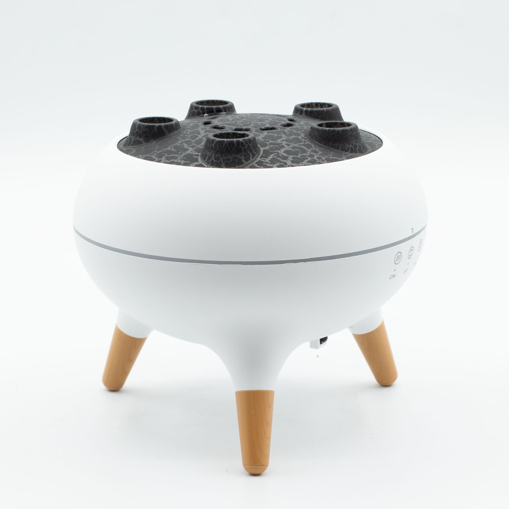 Colour-Changing USB Jellyfish Puff-Effect Aroma Diffuser with Remote, with a white bowl-shaped body, dark perforated top and three tan legs by Quintessential Holistic Health Ltd