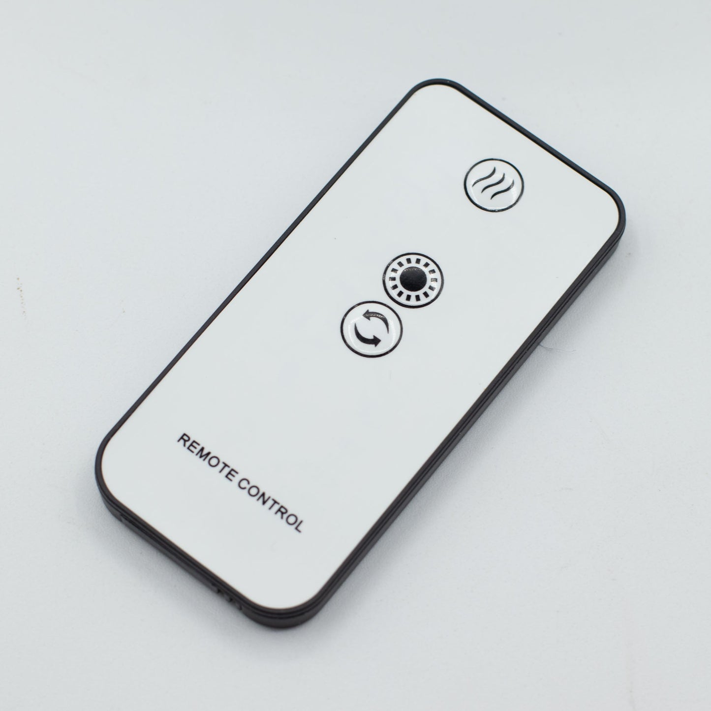 Colour-Changing USB Jellyfish Puff-Effect Aroma Diffuser with Remote, shown as a white remote with three circular symbol buttons by Quintessential Holistic Health Ltd