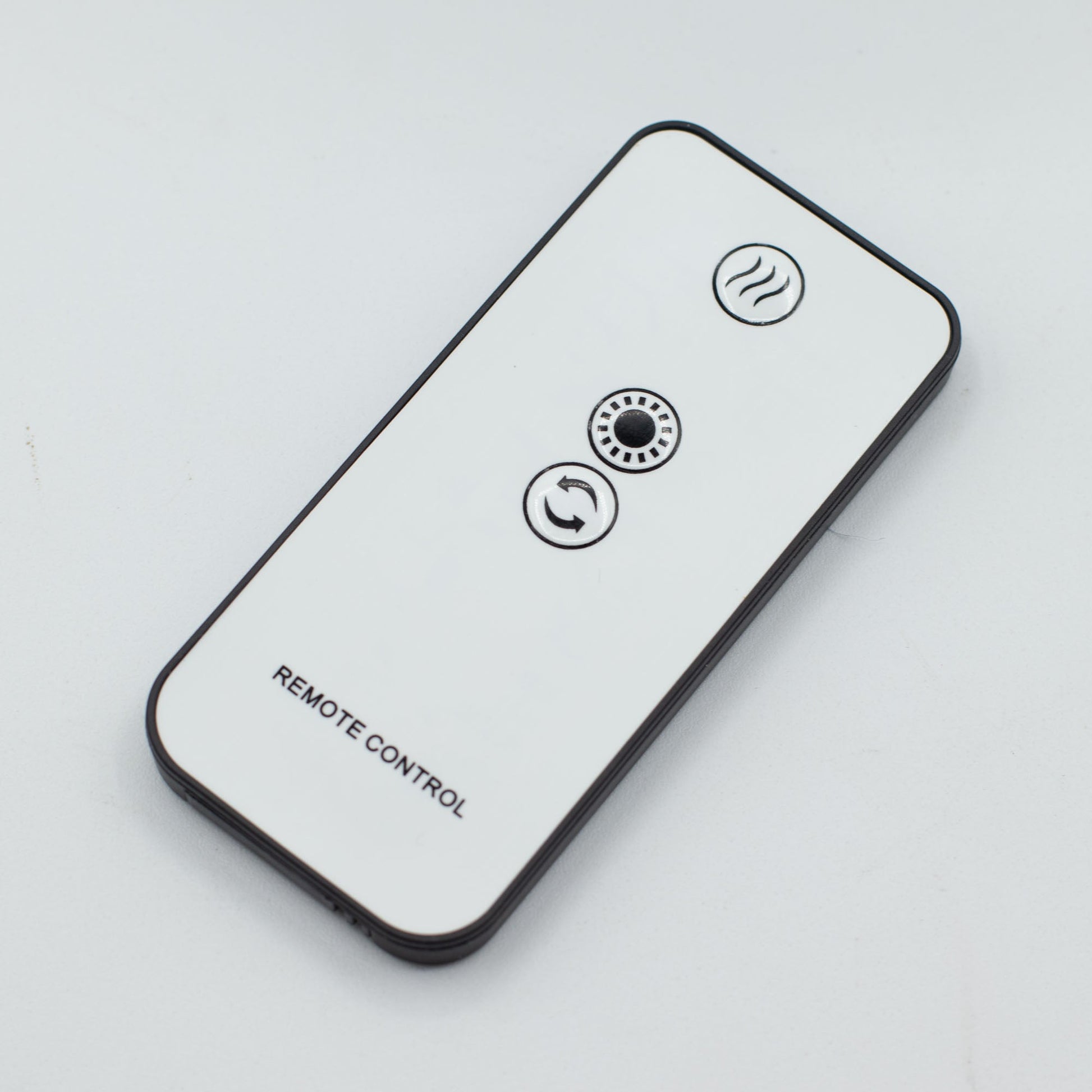 Colour-Changing USB Jellyfish Puff-Effect Aroma Diffuser with Remote, shown as a white remote with three circular symbol buttons by Quintessential Holistic Health Ltd